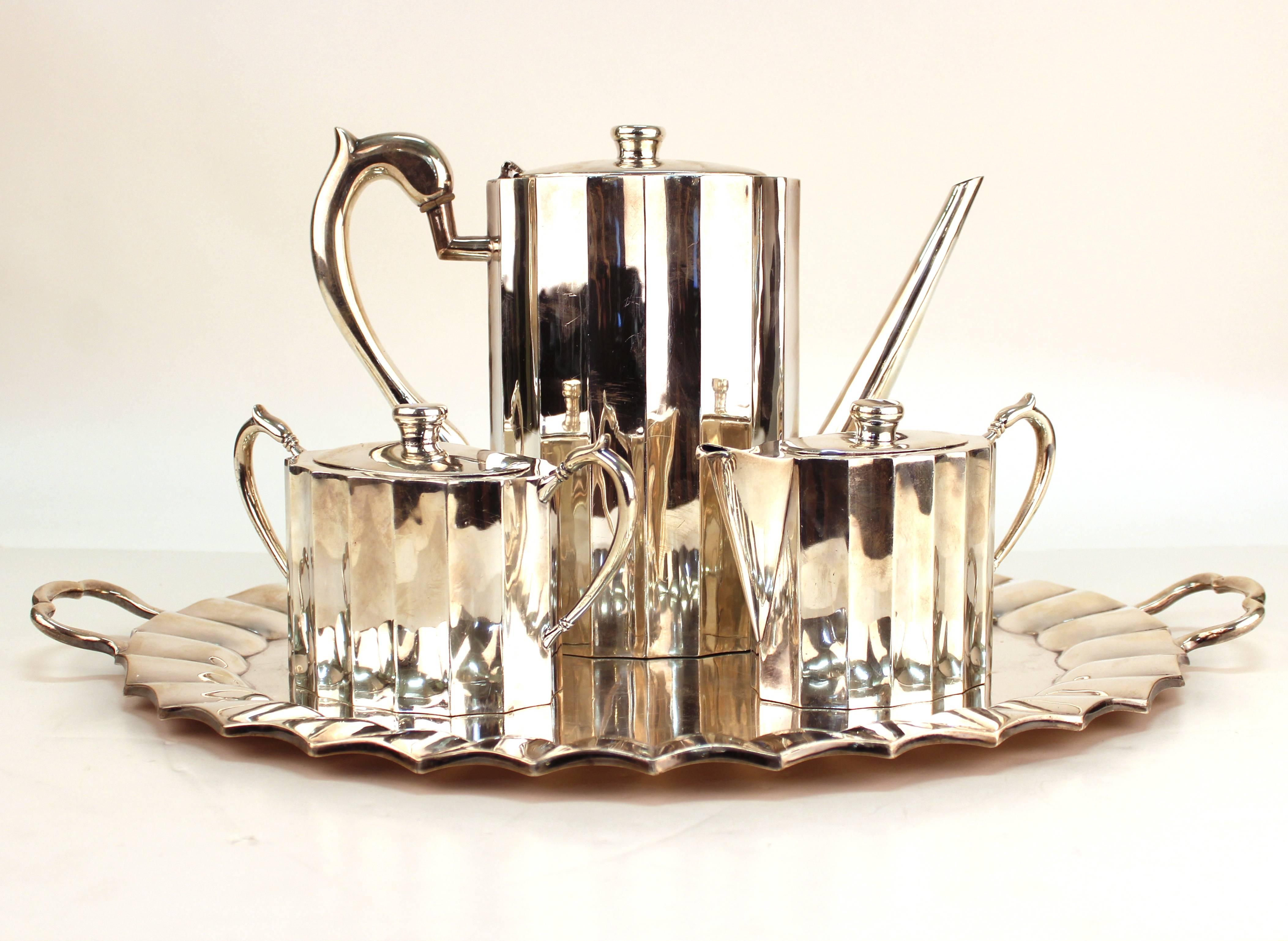 Coffee service set with tray in Mexican sterling silver. Includes four pieces including a coffee pot, creamer, sugar jar and tray. Signed J. Rivaso. Tarnish and scrapes to surface with unhinged lid on the coffee pot. Minor dents throughout. The set