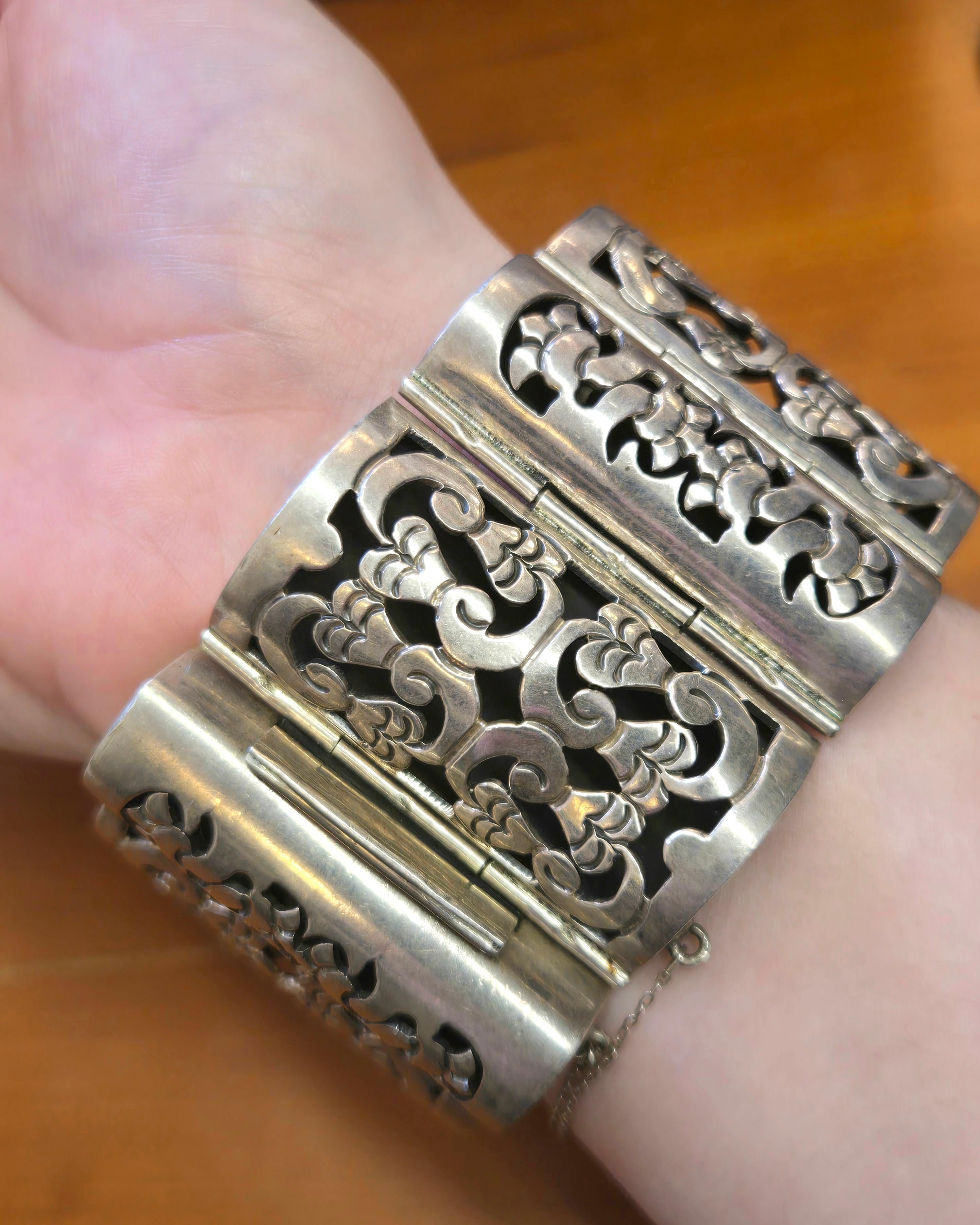 Questo splendido e pesante bracciale in argento sterling proviene probabilmente dallo stesso laboratorio di Los Ballesteros. Caratterizzato da un design shadowbox con maglie a cerniera grandi e piccole alternate a mano, il design curvo è fluido ed