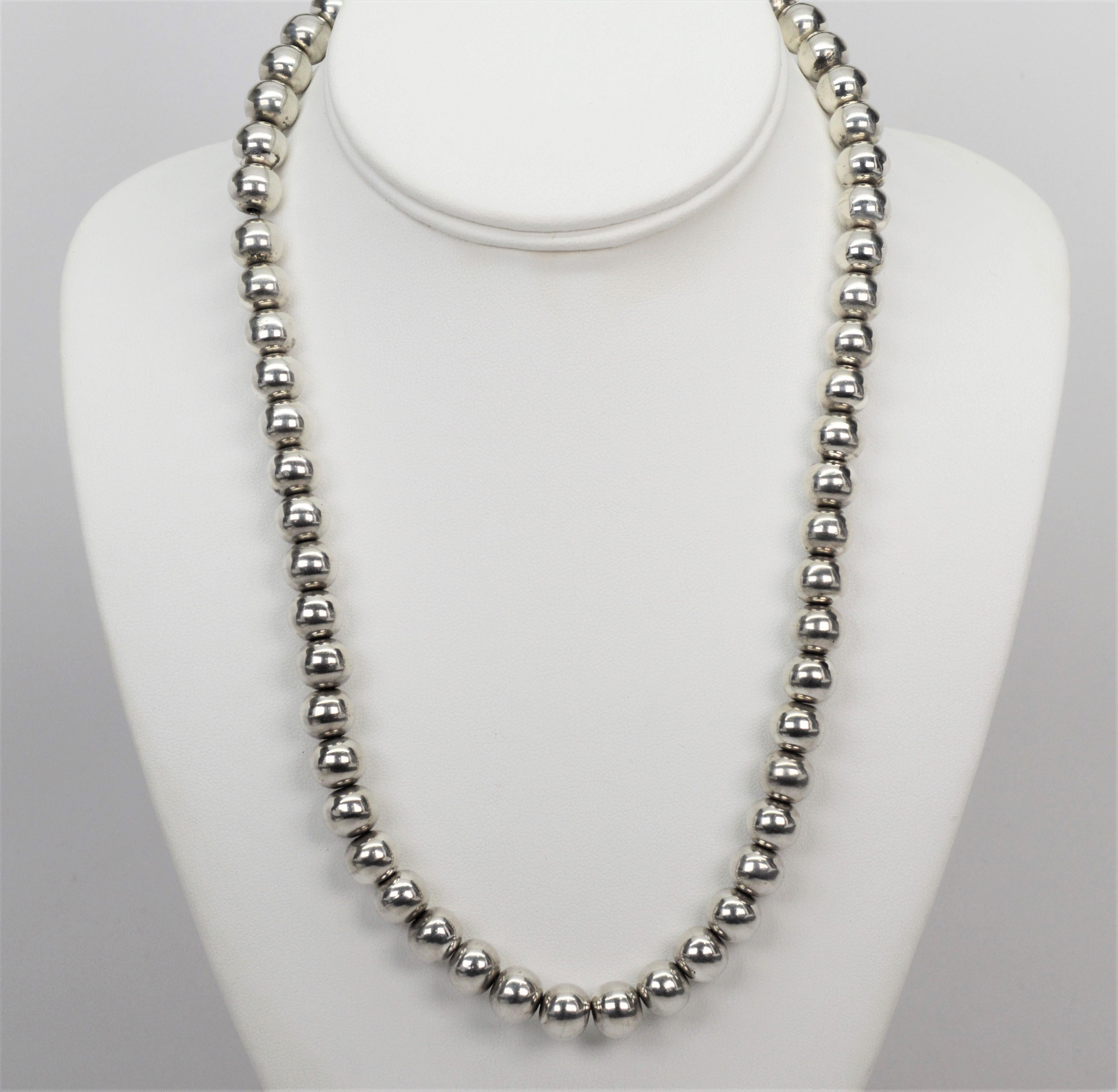 This bright Mexican sterling silver beaded 20 inch necklace has endless possibilities. 
 Hand strung with 56 round 9.75mm beads of .925 sterling silver beads. Finished with a box clasp. Gift boxed. 