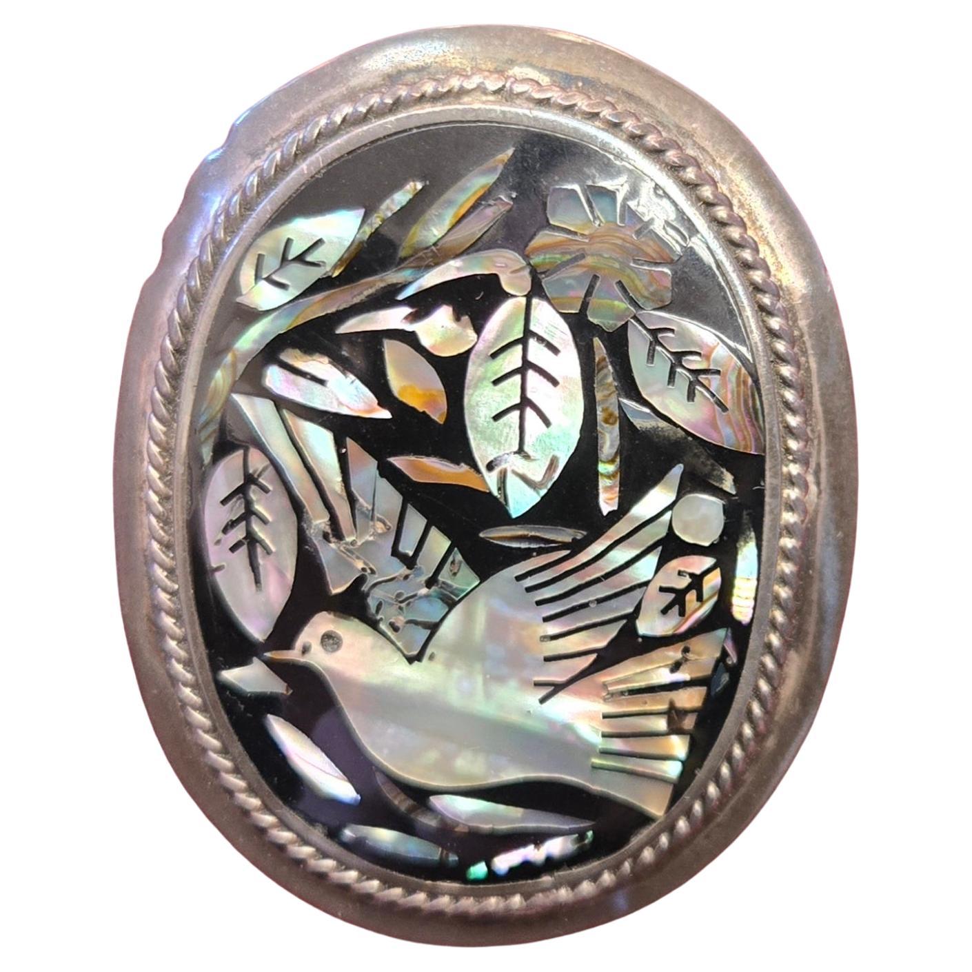 Broche mexicano de plata de ley con incrustaciones de abulón y motivo de pájaro