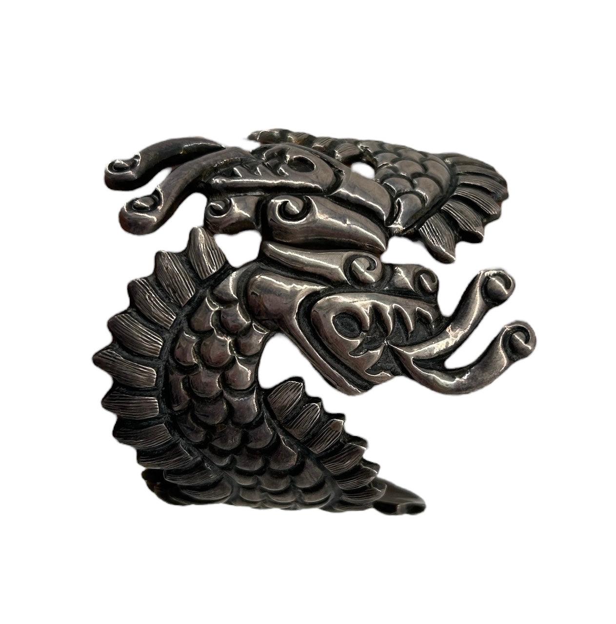 Incredible piece of sterling silver handcrafted into two dragon figures, also known as the Aztec and Mayan feathered dragon deity Quetzalcoatl. A true piece of art.

Approximately 3 inches tall, nearly 8 inches around closed.
Adjustable and can fit