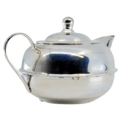 Vintage Mexican-style smooth silver pot with a rounded shape