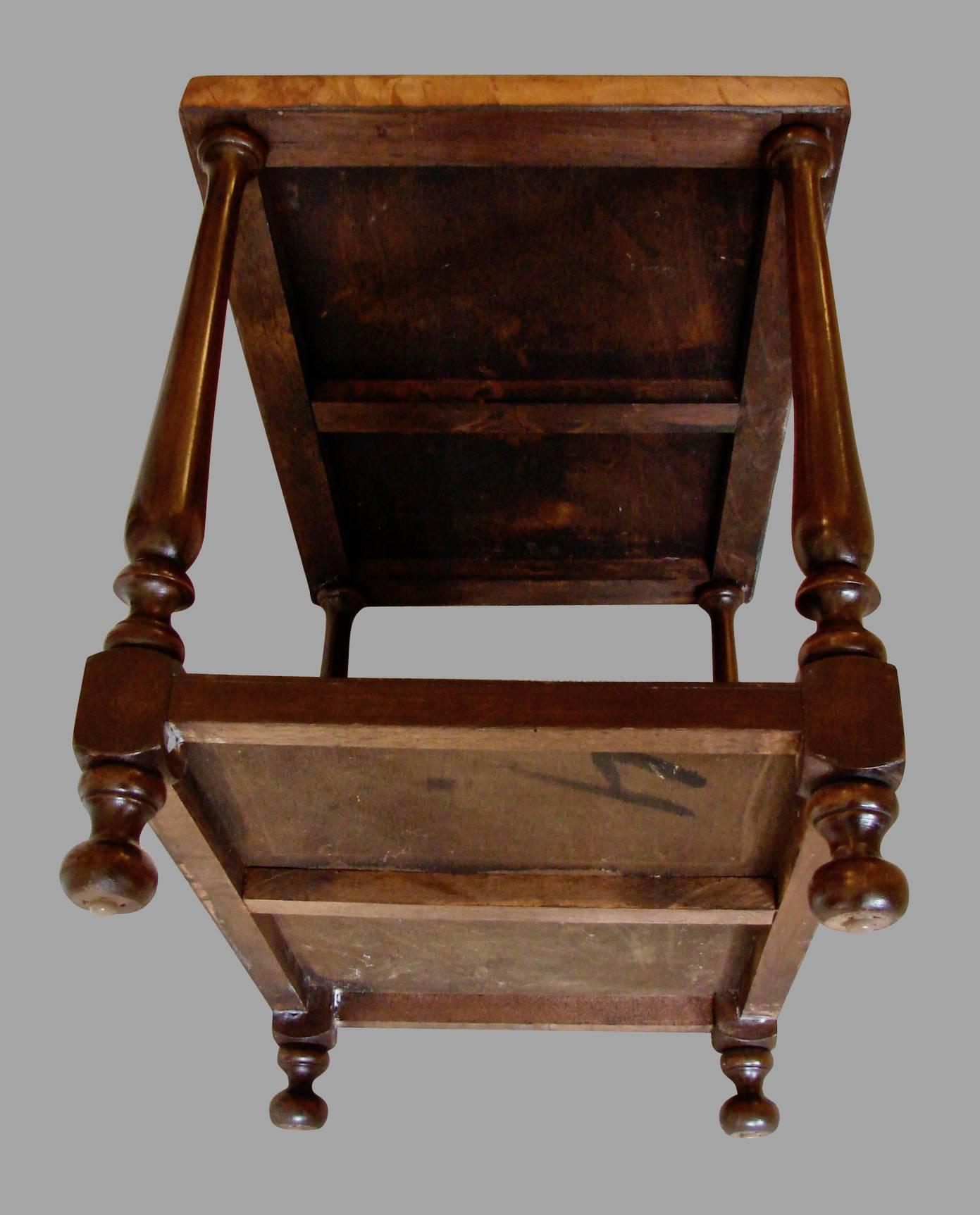 A Mexican hardwood side table with a lower shelf, the top covered with an embossed 