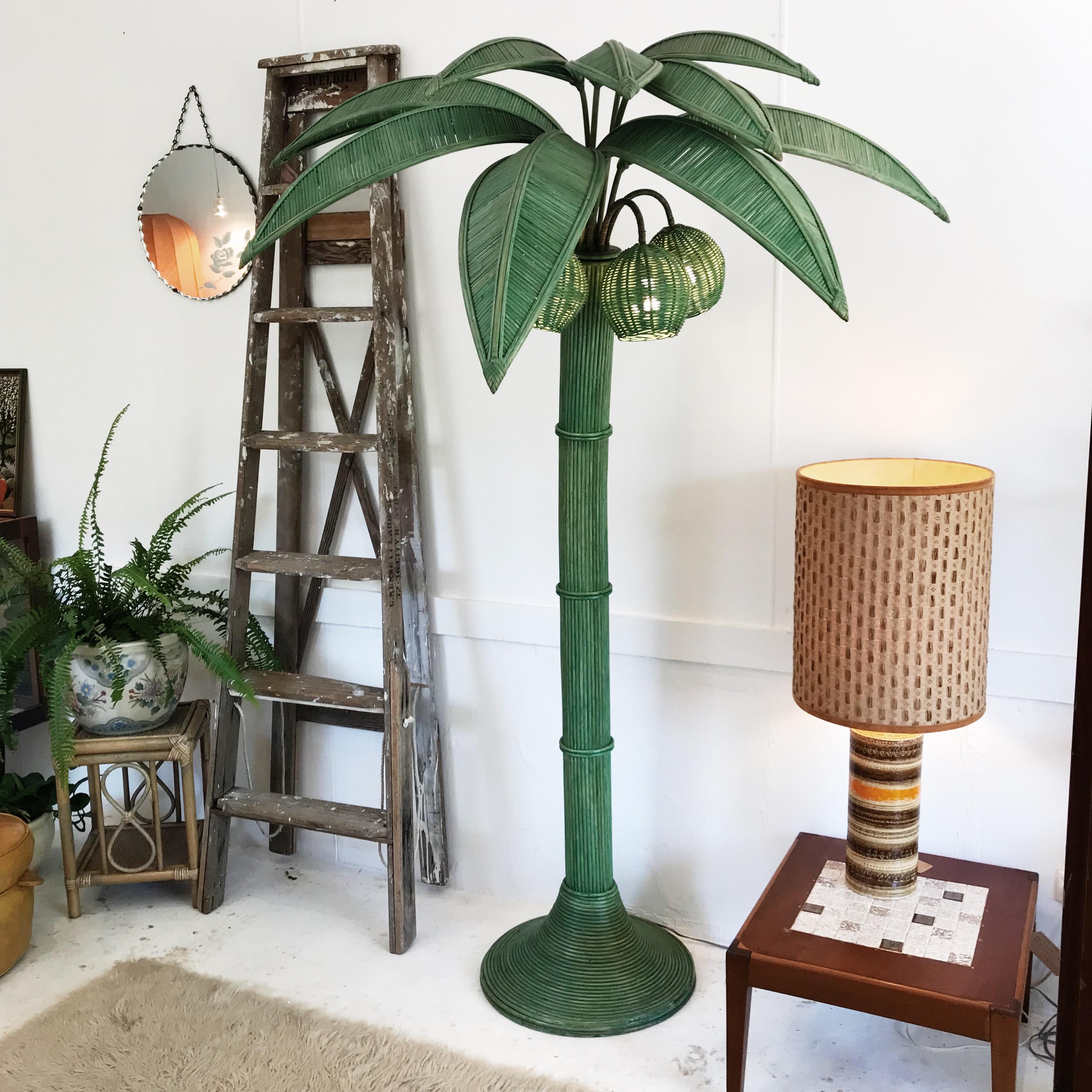 Original vintage wicker rattan palm tree floor lamp by Mario Lopez Torres. Gorgeous lines and timeless design, this floor lamp serves equally well as a subtle environmental and decorative piece as it does as a crowd pleasing, show stopping