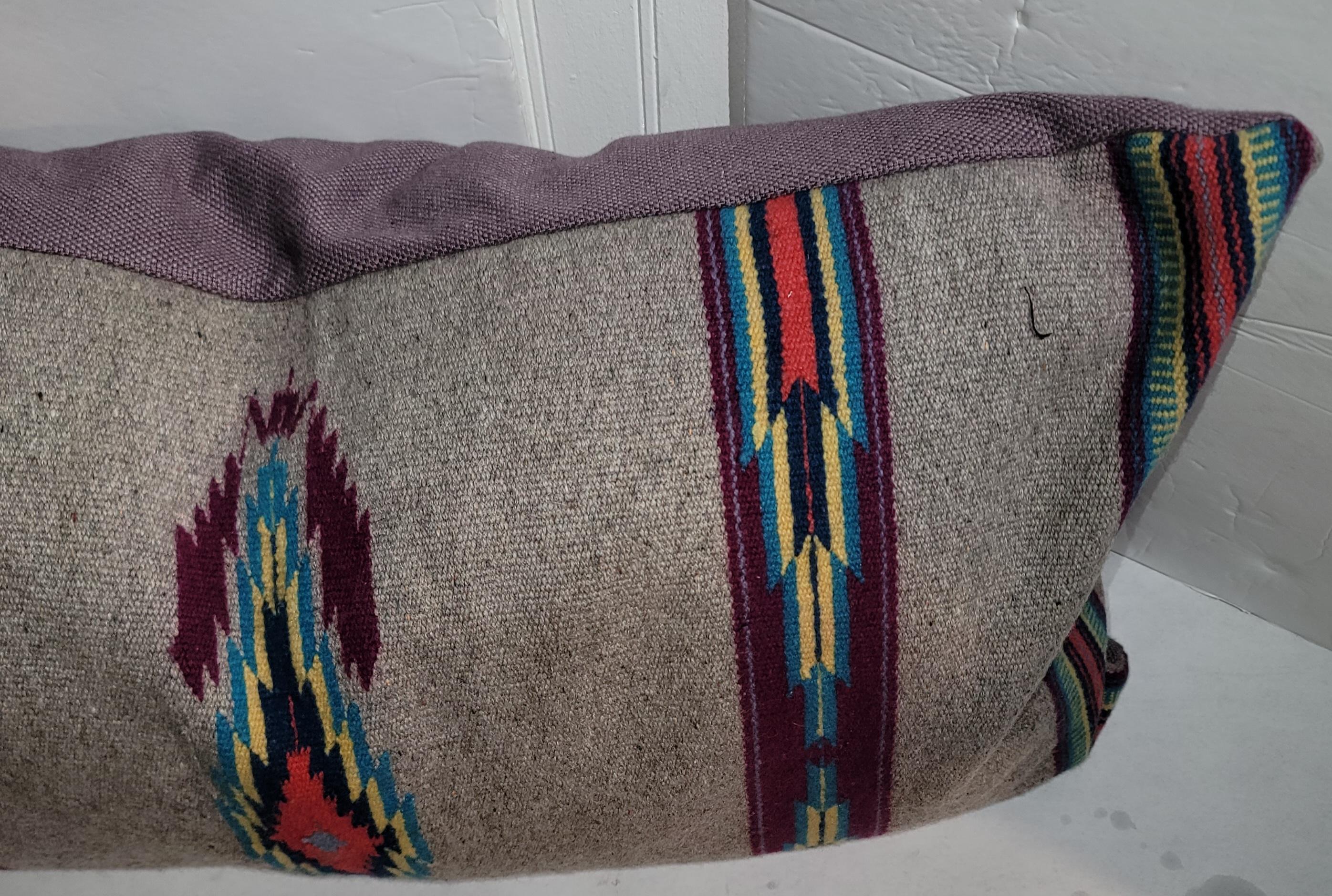Wool Mexican Serape Bolster Pillow with linen backing. Strong Colors make this pillow stand out. The dark grays are a great use of a background color with deep red and some blues and browns. Fitted with custom made down and feather inserts.