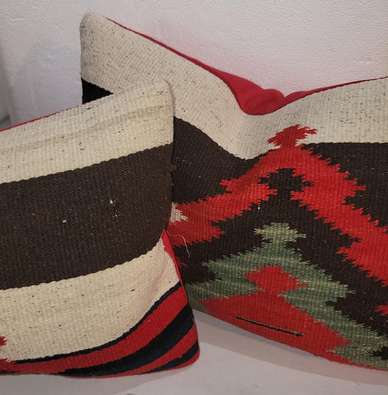 This fine pair of Mexican /American Indian weaving pillows. The condition is very good and have cotton linen backing.The inserts are down & feather fill. Sold as a pair.

larger pillows measures 17 x 32
Smaller pillow measures 17 x 12