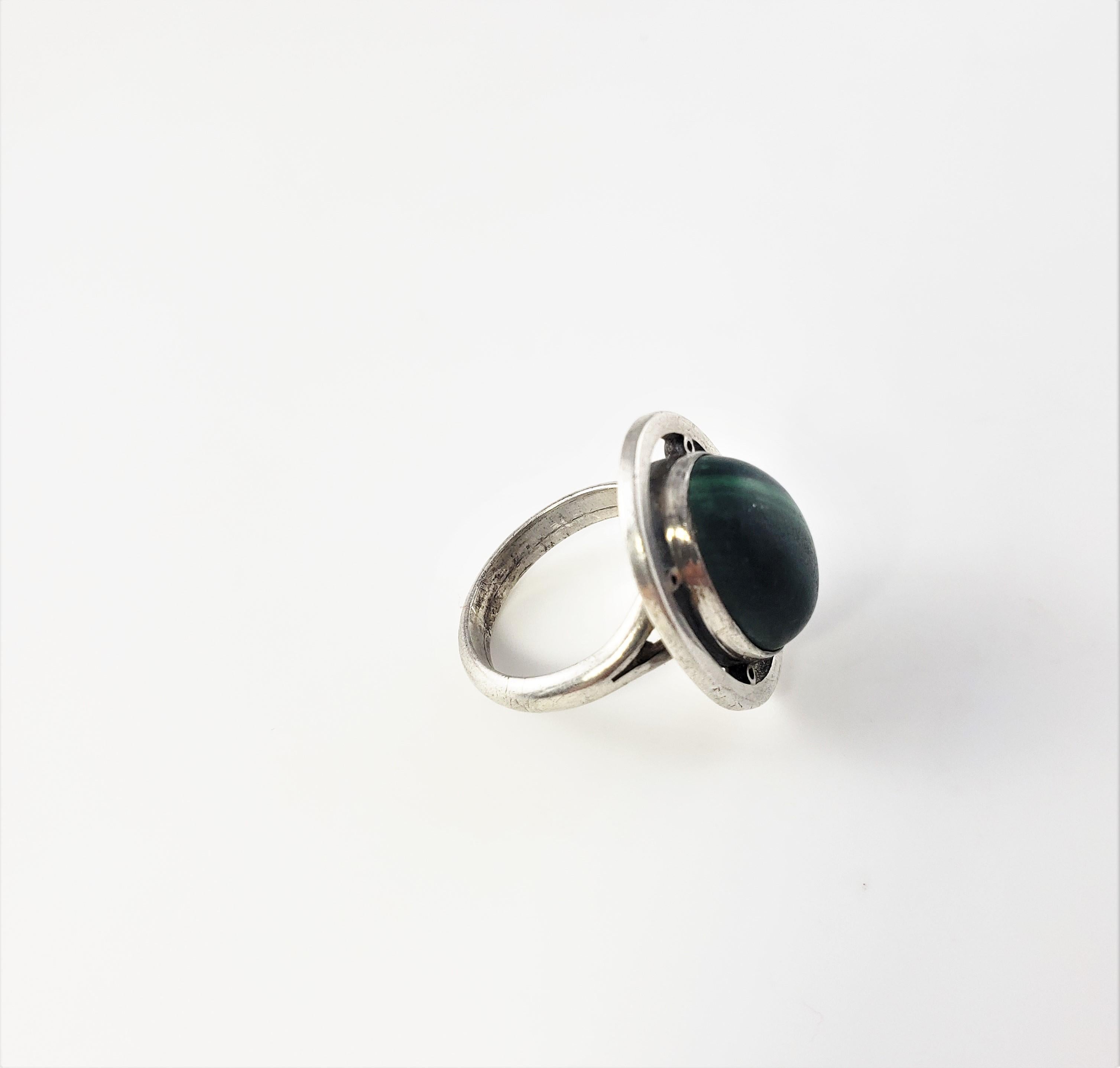 Vintage Mexico Carmen Beckmann Sterling Silver Malachite Ring Size 5.75-

This lovely ring features on oval malachite stone (16 mm x 11 mm x 10 mm) s et in beautifully detailed sterling silver. Top of ring measures 22 mm x 18 mm. Shank measures 3