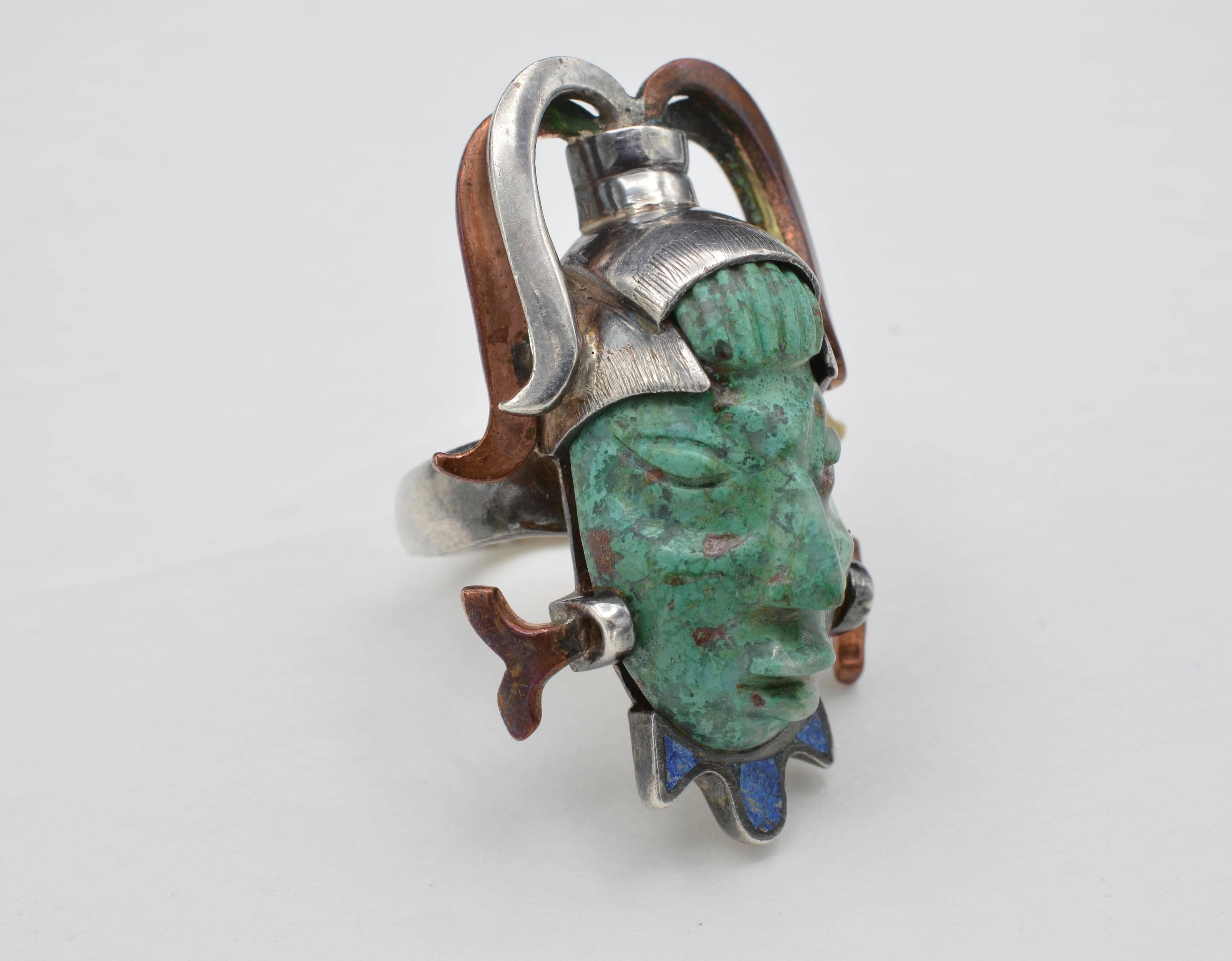 This very unusual carved Indian face with inlayed lapis neck design in set in sterling silver, brass and copper. The ring is a size 7 and it is adjustable. A wonderful conversation piece!!