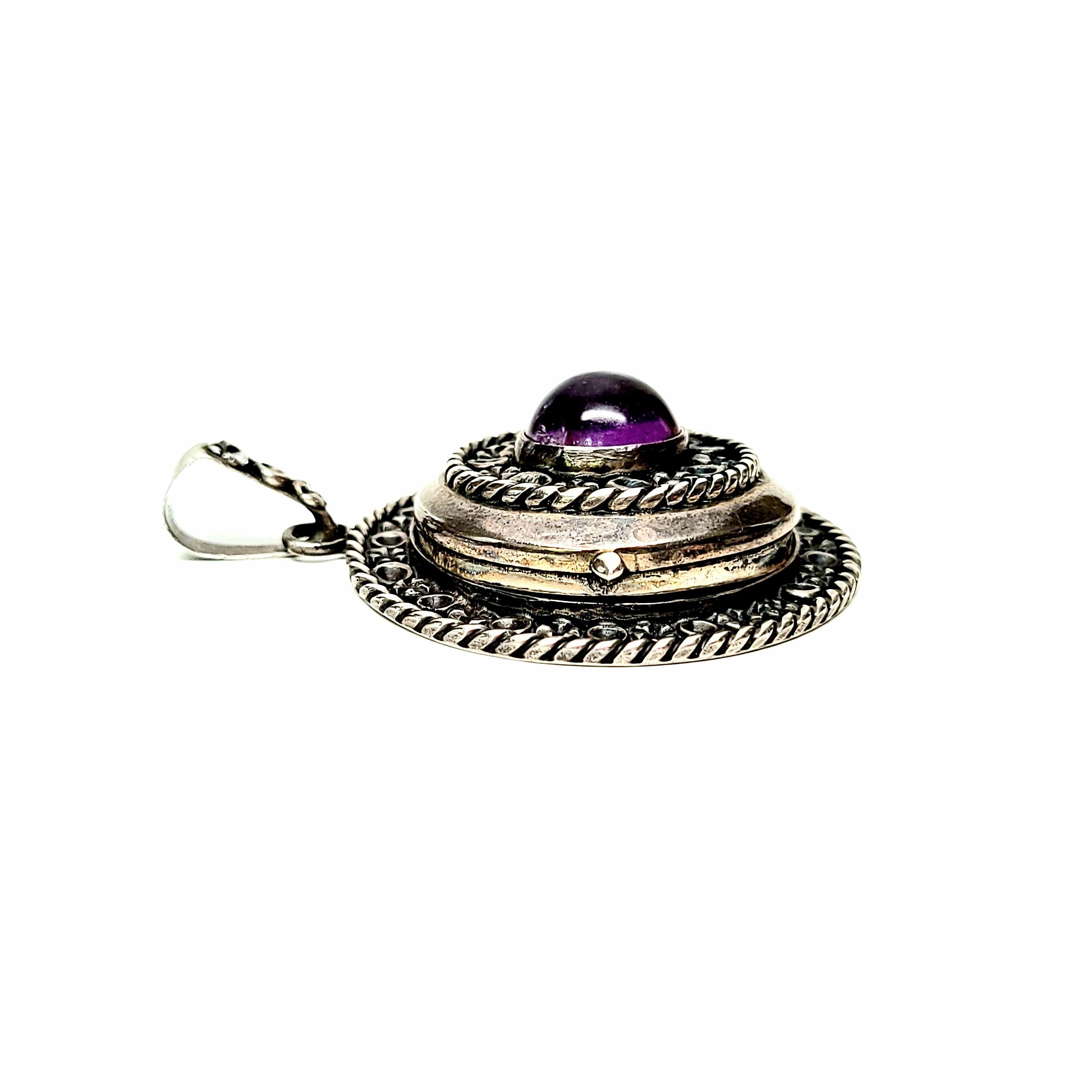 Vintage Mexico sterling silver and amethyst locket.

Beautifully detailed round locket featuring a round amethyst cabochon at its center. Eagle 1 mark dates this piece to 1949-79.

Measures approx 2 1/2