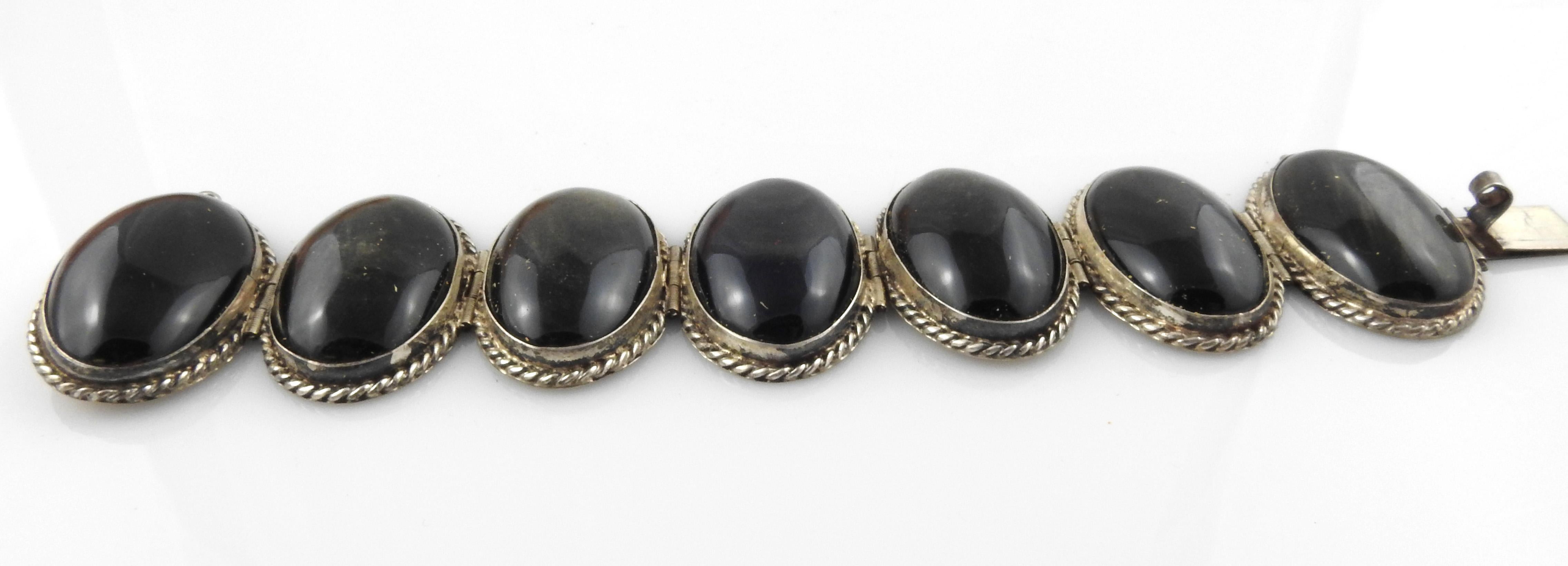Mexico sterling silver large bezel set obsidian bracelet.

Marking: STERLING 925 MEXICO, MEXICAN(HS?) 925.

Measures approx. 7 3/4
