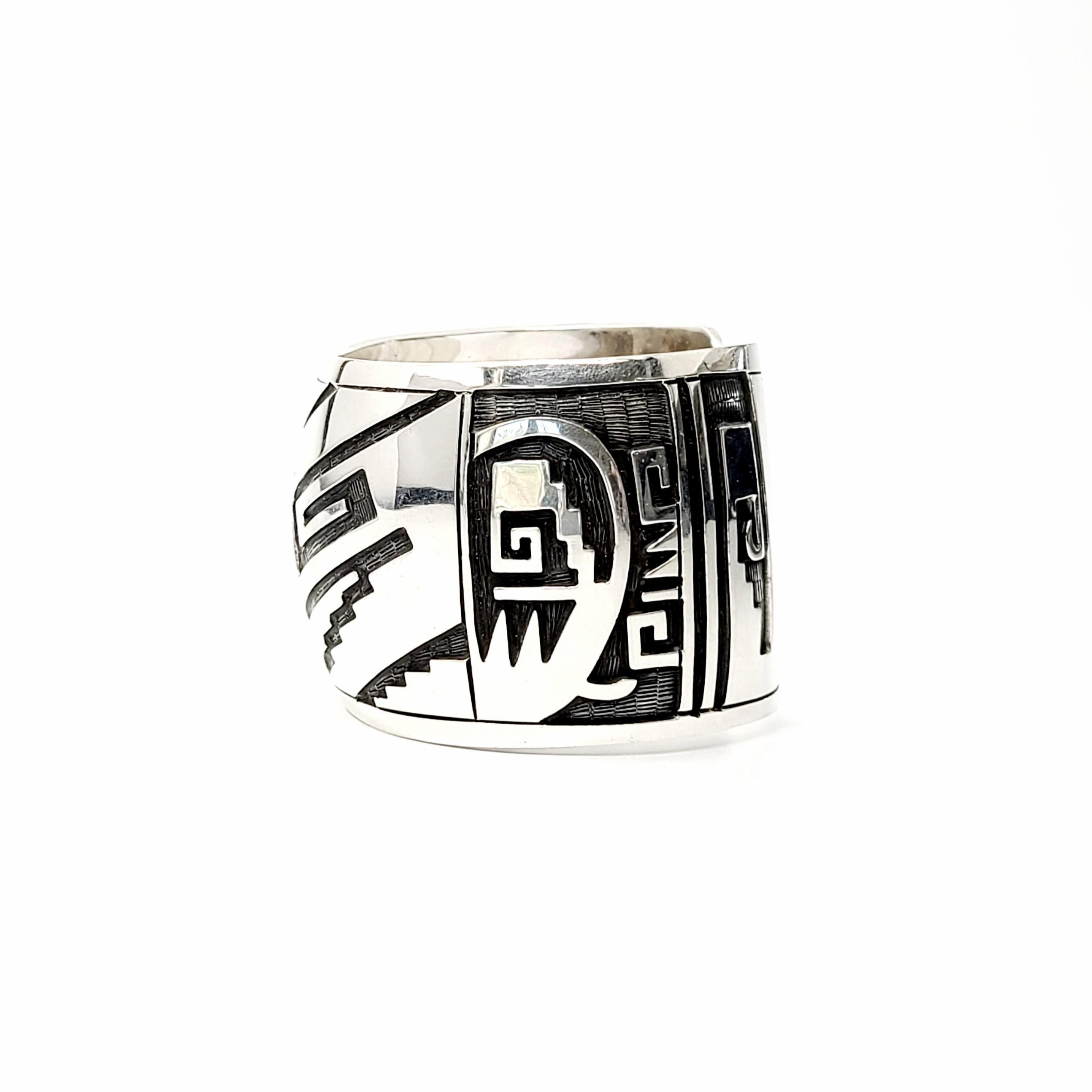 Wide sterling silver cuff bracelet.

A modernist wide cuff bracelet with unique and interesting design featuring smooth, polished overlays with black etched accents.

Measures approx 6 1/2