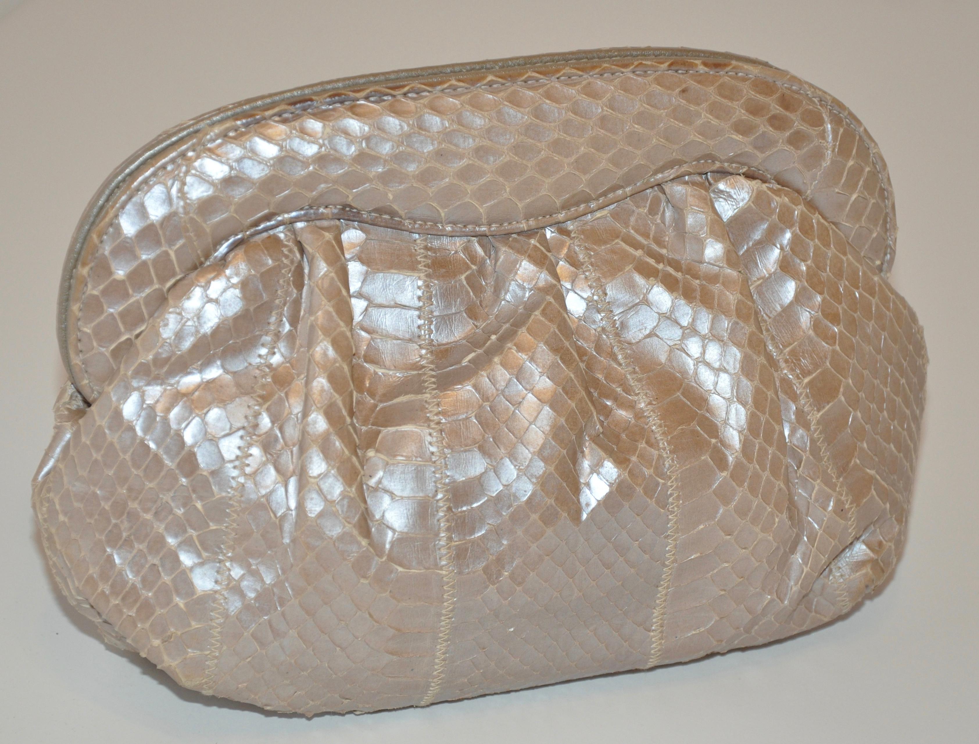        Meyer wonderfully elegant Pearl-tone Snakeskin clutch with optional shoulder strap (measuring 18 inches in height). Leather accents of thee same tone, this elegant clutch measures 8 inches in length along the top and 9 1/2 inches along the