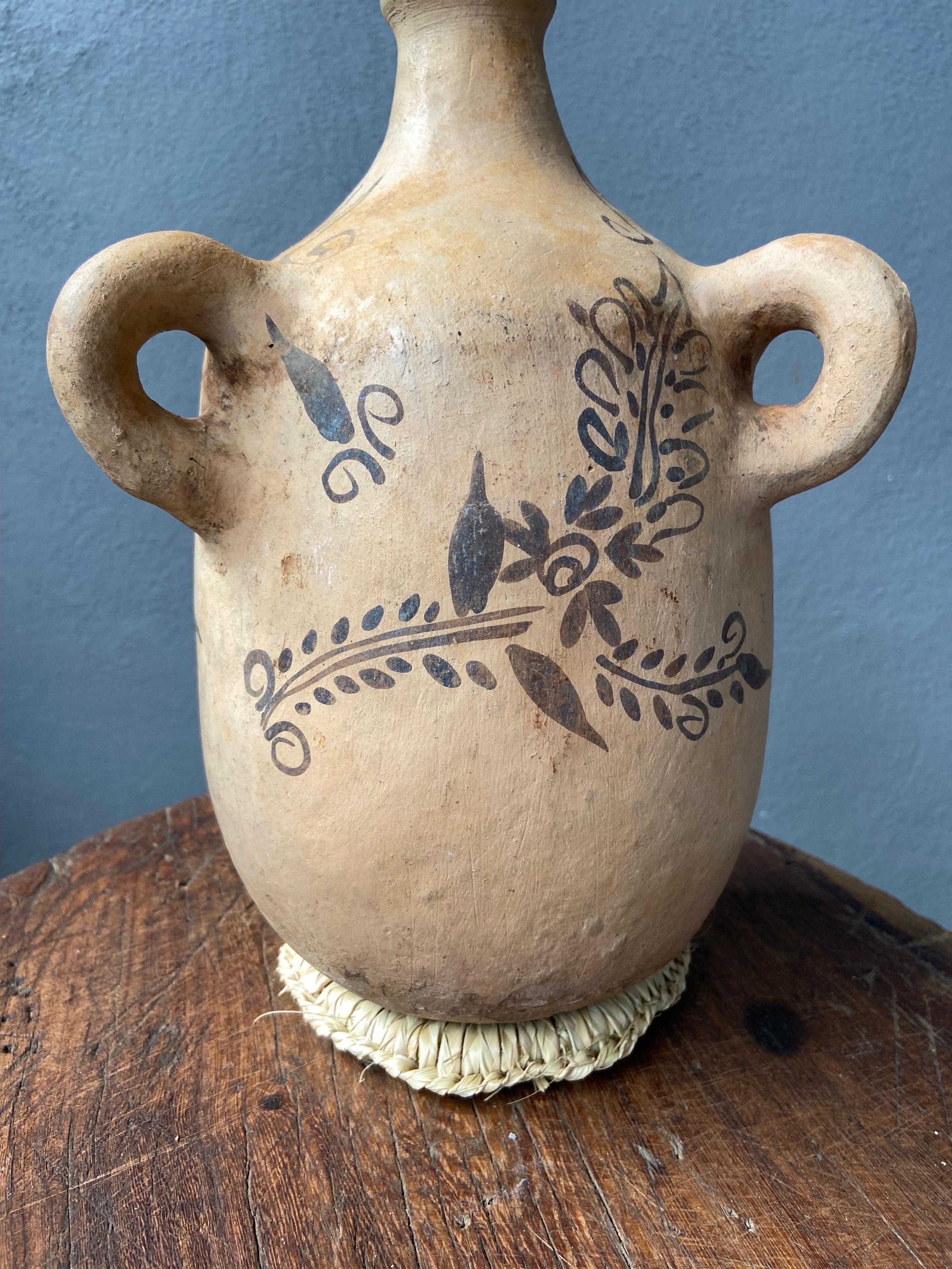 Hand - painted mezcal jug from Tuliman, Guerrero, circa 1940´s. The vessel has rope rings for travel portability.