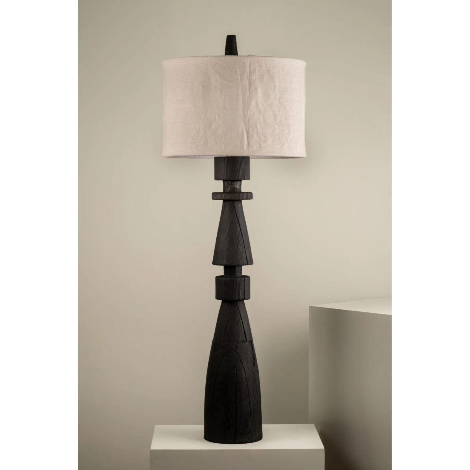 Mezquite Floor Lamp by Isabel Moncada
Dimensions: Ø 60 x H 181 cm.
Materials: Linen and pine wood.

Like a chess bishop, Mezquite makes its presence felt in a resounding manner. It has a sturdy wood base, its dark finish gives great character and