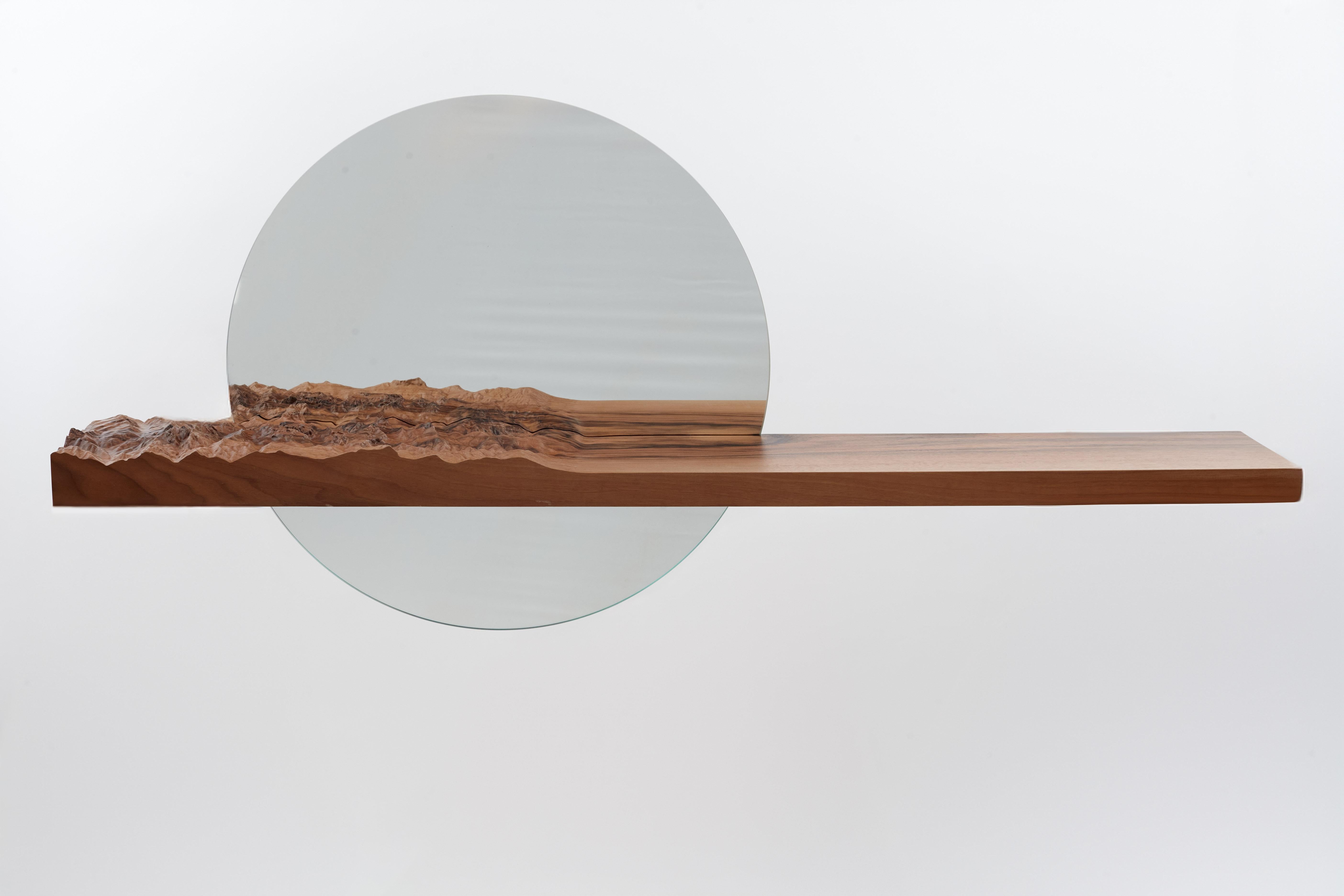 Mezzocielo Natural Oak, Bevelled Mirror by DOLOMITISCH
Dimensions:  W 130 x D 20 x H 60 cm
Materials: Natural Oak, Bevelled Mirror

In the reflection of dawn, a mountain range ascends, marrying stillness with the wild. A mirror meets sculpture; a