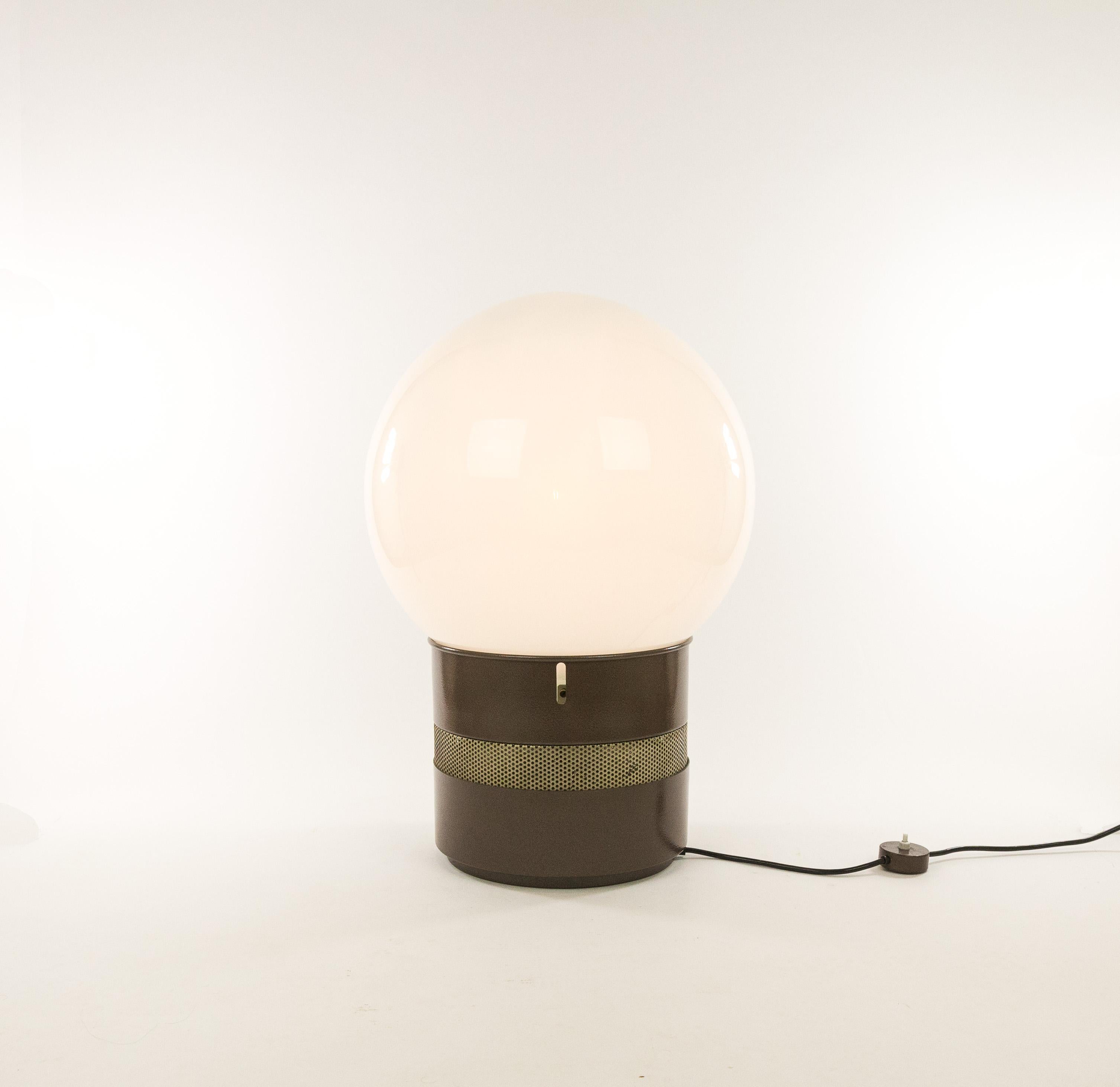 Mezzoracolo table or floor lamp by Italian architect Gae Aulenti, executed by Artemide. This is the smaller version, but it is still 67 cm high. The other version is named Oracolo, and the height of this lamp is 140 cm.

A large white globe in