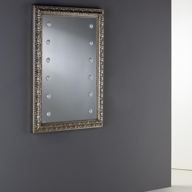 Combining a classic, handcrafted wood frame with gold leaf and innovative lighting technology, this unique lighted mirror is a striking statement piece that will effortlessly elevate any interior. Part of the MF line, the reflective surface is