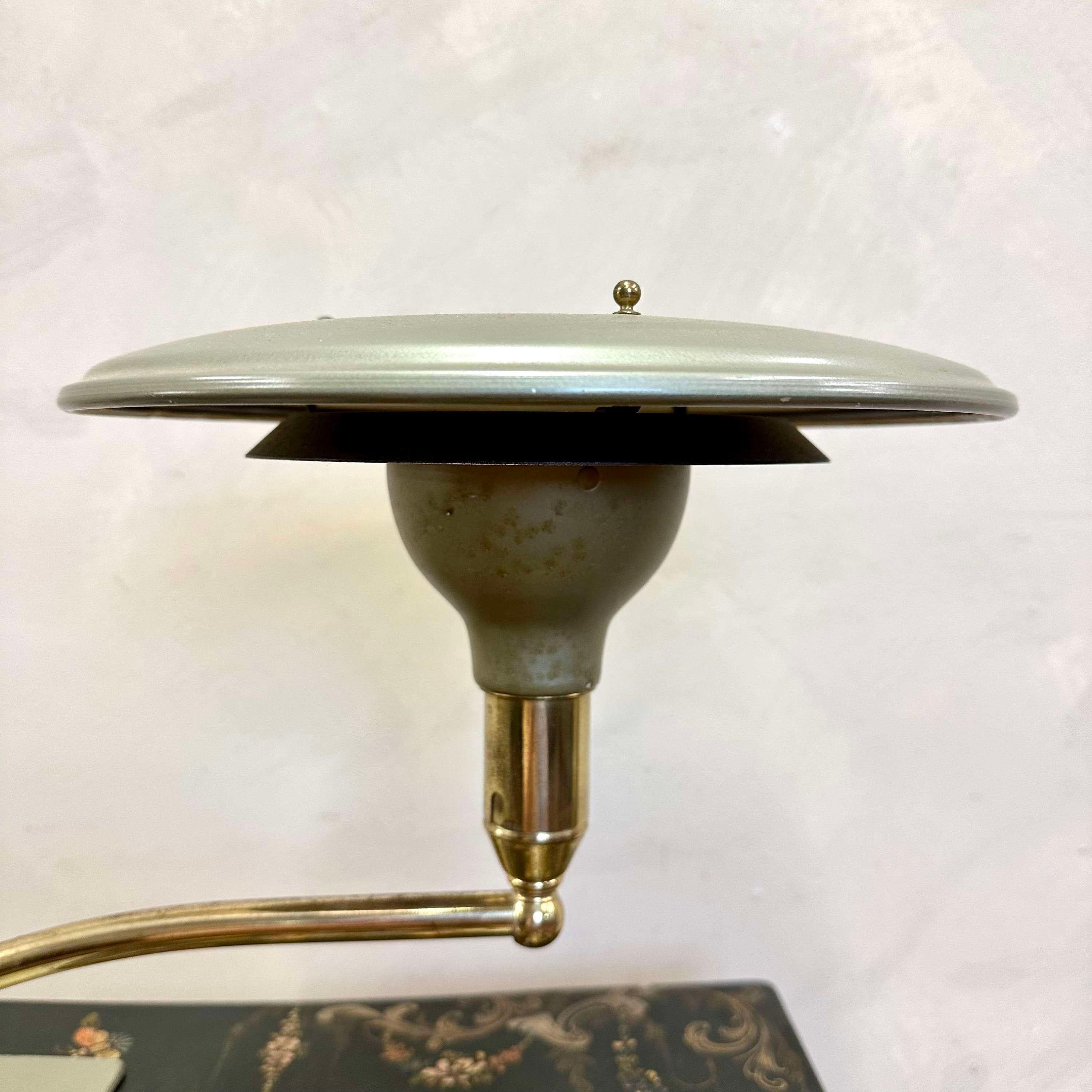 Mid Century Desk Lamp by M.G Wheeler.
A heavy steel base supports an angled, tubular brass arm on a swivelling ball-joint.
All in the original factory finish, with makers markto inner shade.
Light wear commensurate with age, but not detracting.
USA,