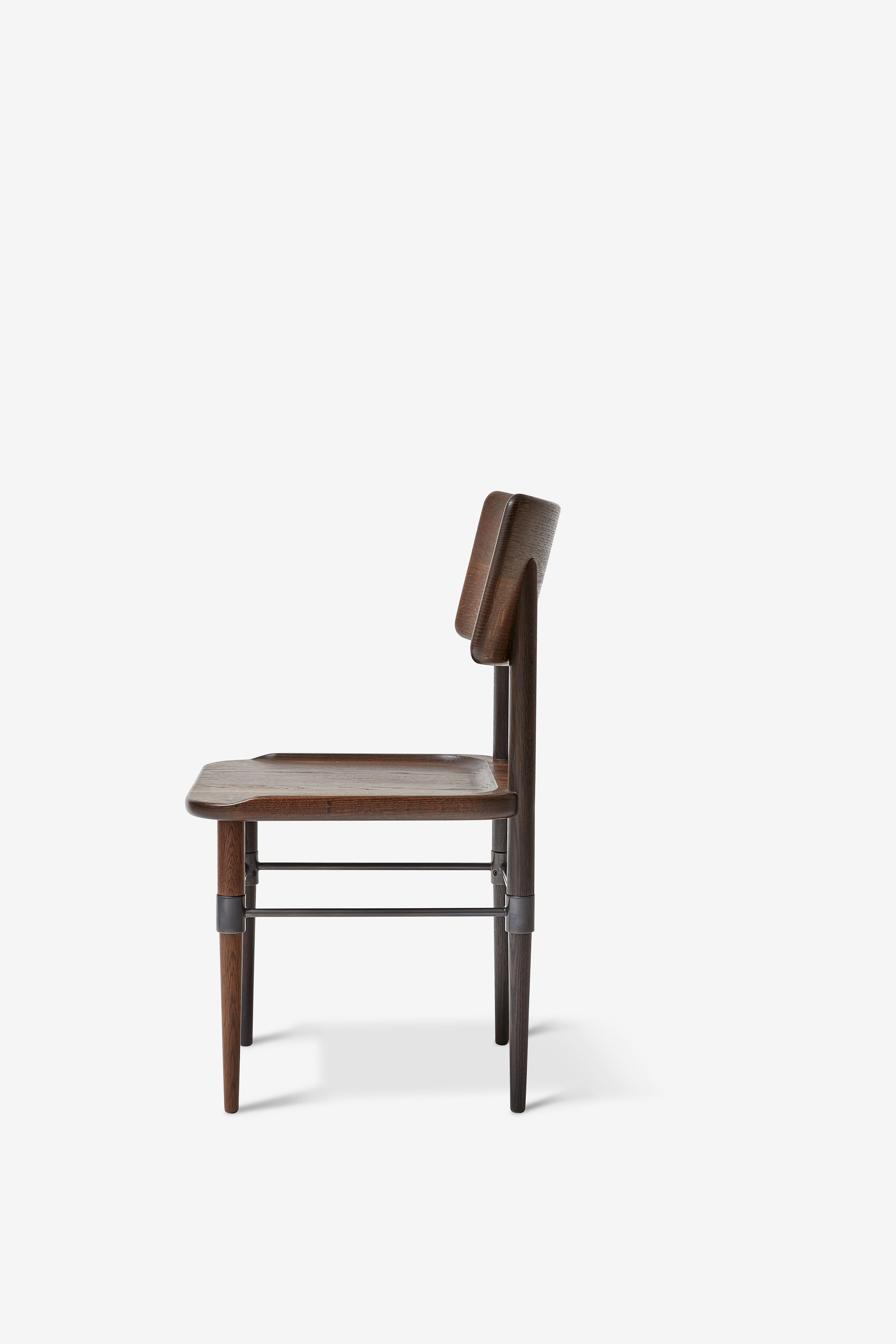 MG101 Dining chair in smoked oak and blackened metal. The seat pad is not included and can be ordered separately.

The Holmen series originates in a series of furniture, which was developed for Michelin restaurant 108 in Copenhagen. The common