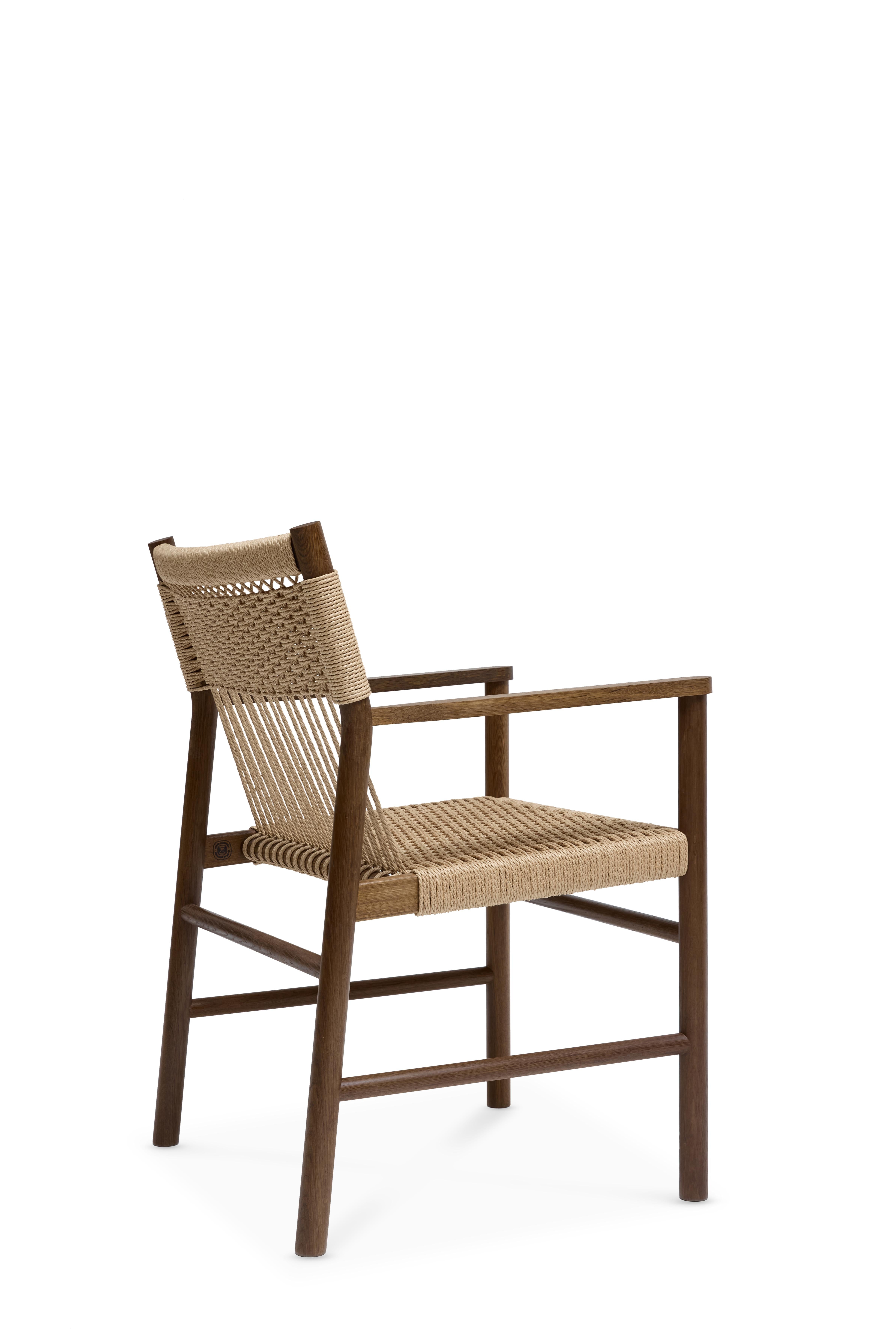 MG106 Dining Chair With Armrest by Malte Gormsen
Dimensions: D 58.2 x W 57.2 x H 83 cm.
Materials: Smoked oak, natural paper cord.

Available in Nature, Raw Nature, Soap, Smoked, and Dark Nature.

Malte Gormsen Møbelsnedkeri is a cabinetmaker who