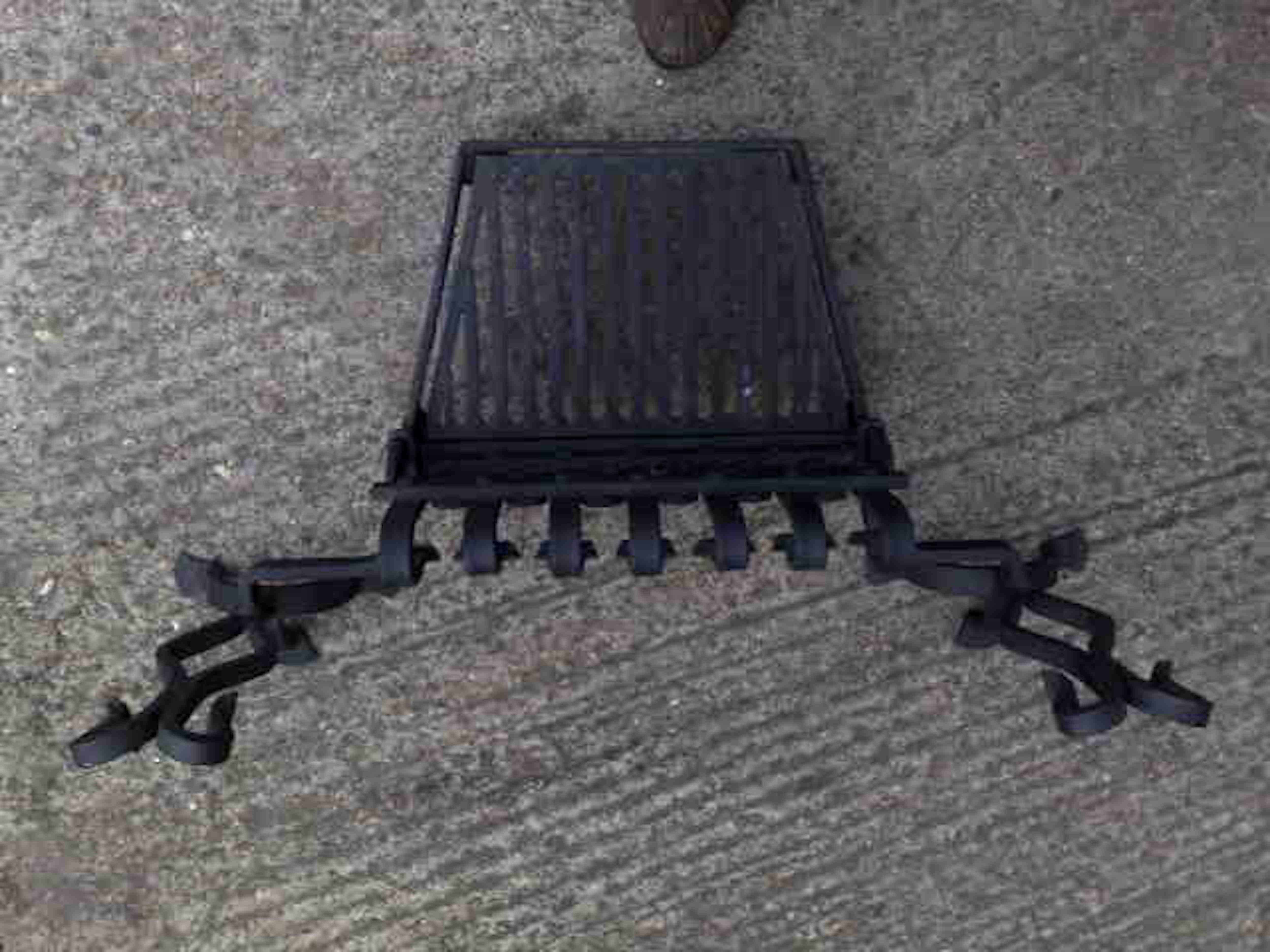Attributed to M.H.Baillie Scott. A hand forged iron grate with integrated andirons. Scroll details to the top and to the front.
The grate measures 12