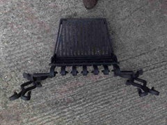 M.H. Baillie Scott Attributed, a Hand Forged Iron Grate with Integrated Andirons