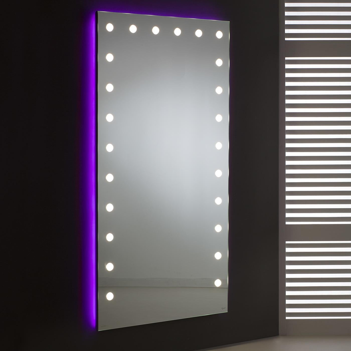 Exuding elegance from top to bottom, this lighted mirror provides the optimal illumination from all angles. Impeccable crafted, the mirror is mounted on a silver anodized aluminum frame complete with a side-mounted actuator. The 24 opaline lenses,