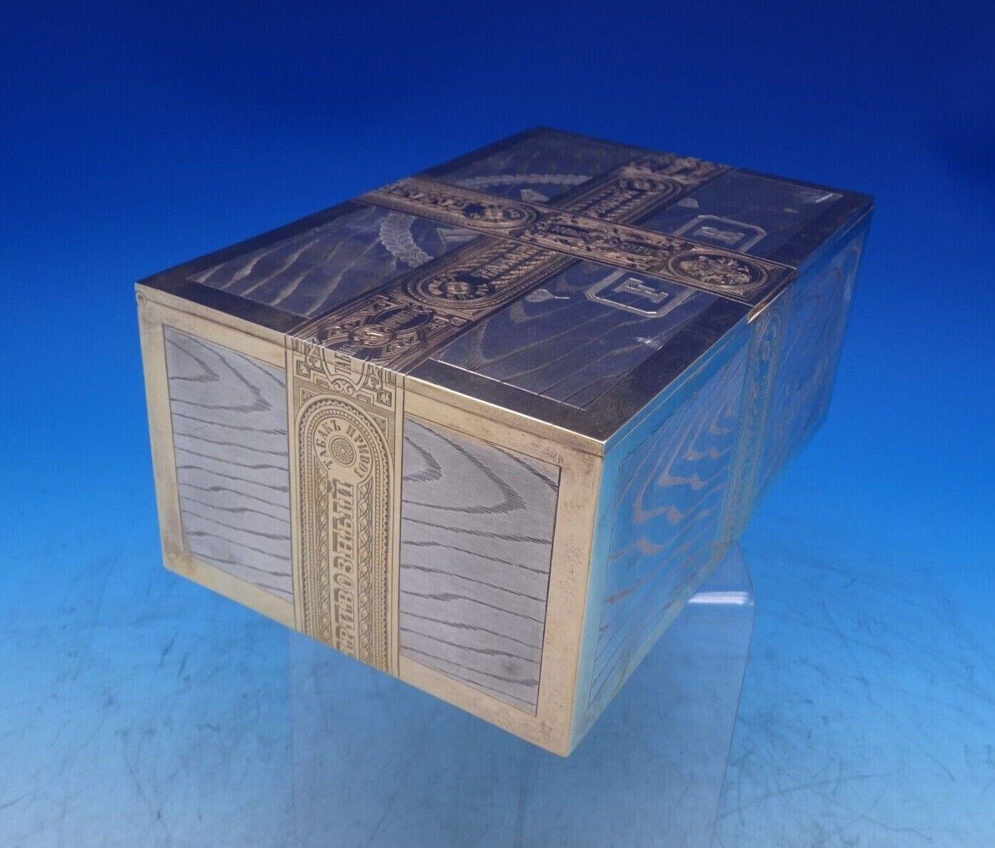 MH

Extraordinary MH Russian .875 silver cigar box dated 1886, assay IYS (Ivan Yev Stigneev). This box features trompe l'oeil wood panels with realistic grain. The center of lid is engraved and has crossed Russian tax bands in gilt, and has an