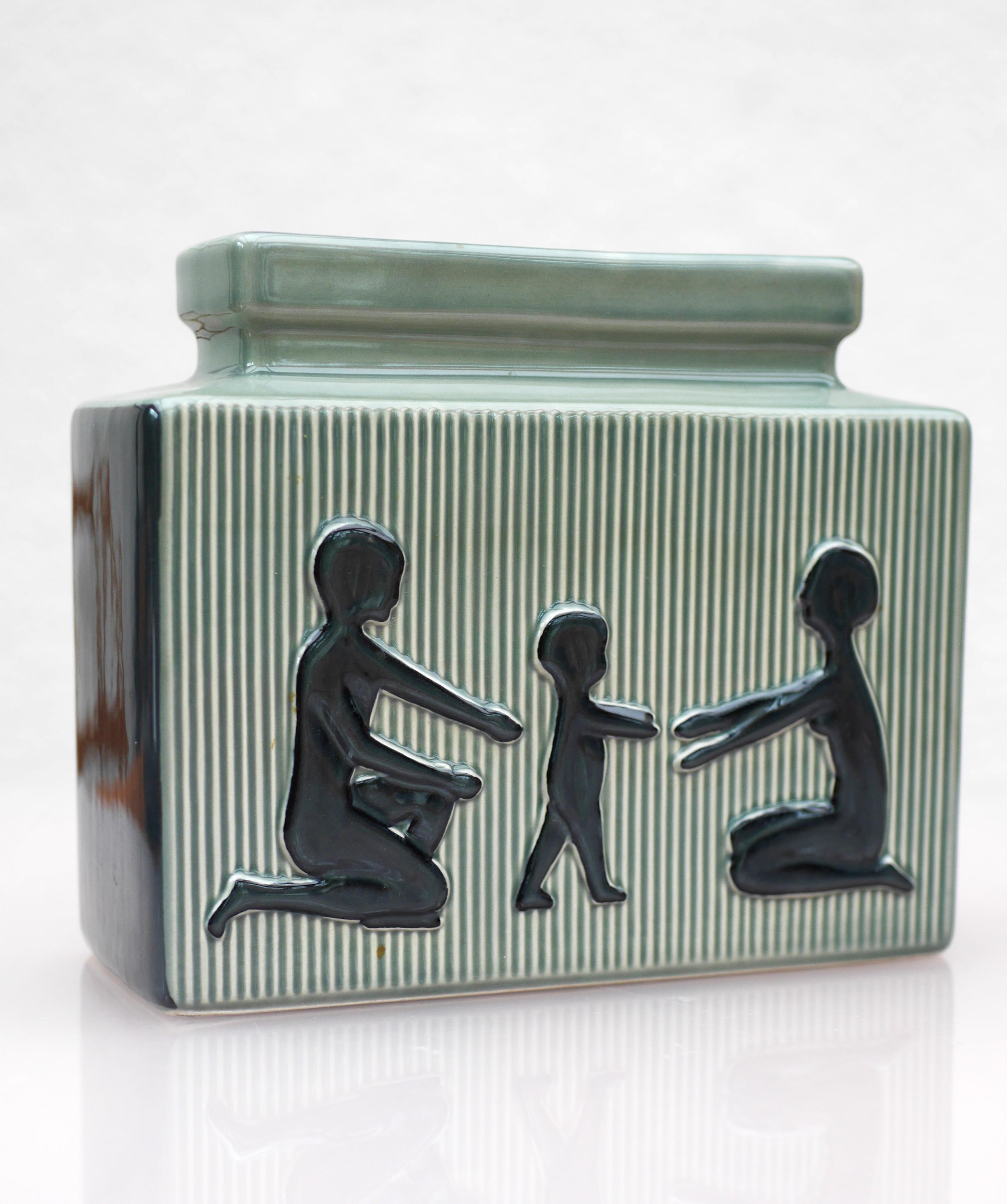 
  Vintage porcelain vase from made by Svend Aage Holm-Sörensen for Söholm, Denmark. An unusual but beautiful ceramic vase made by Einar Johansen for Söholm, Denmark from 1950s. It depicts a child learning to walk, and it has a special feeling to