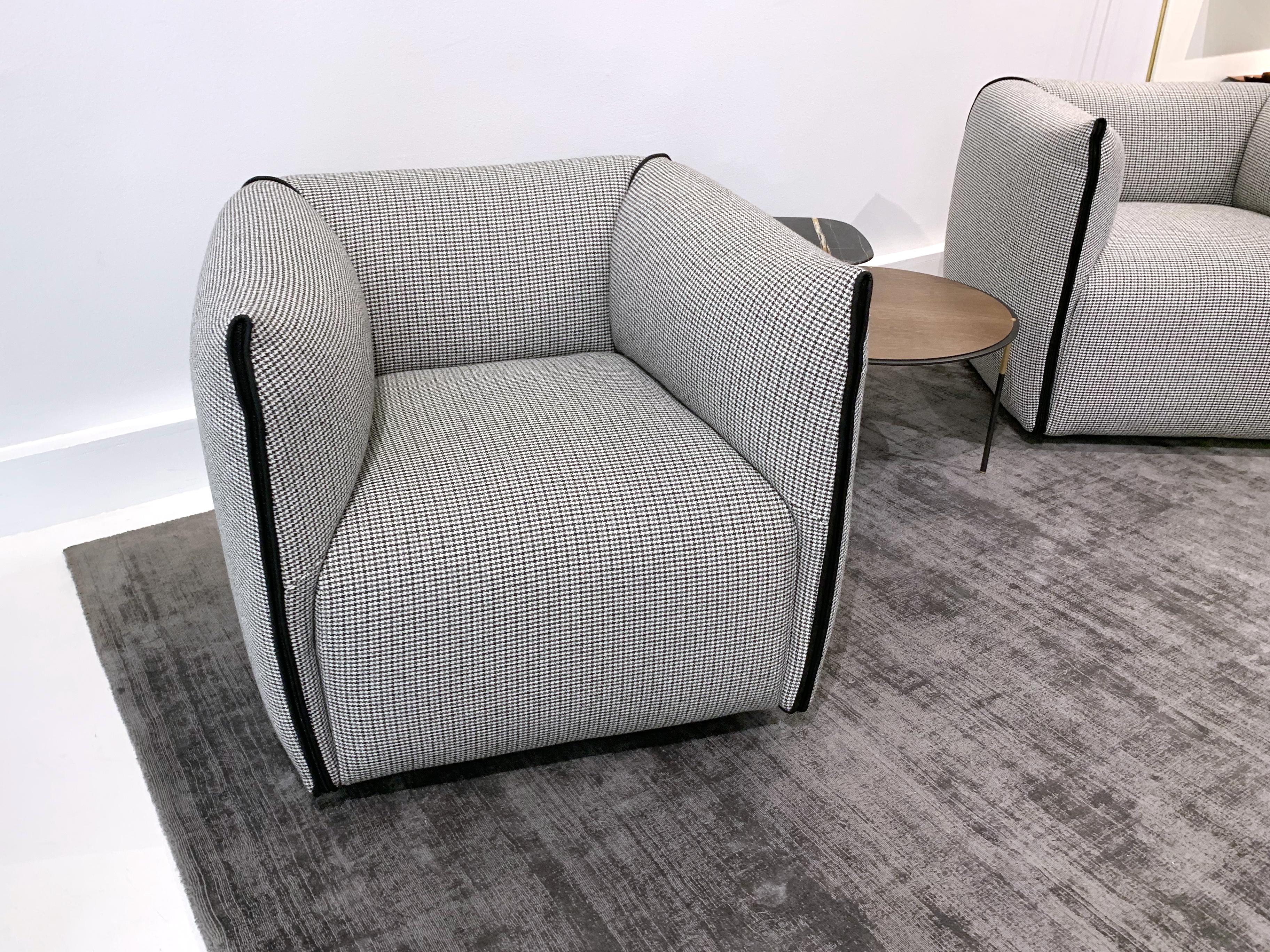 Mia armchair upholstered in gray houndtooth fabric with black contrast trim and shown with return-mechanism. Perfect for any living room. Designed by Francesco Bittoni in 2016. 

Dimensions: 34.3