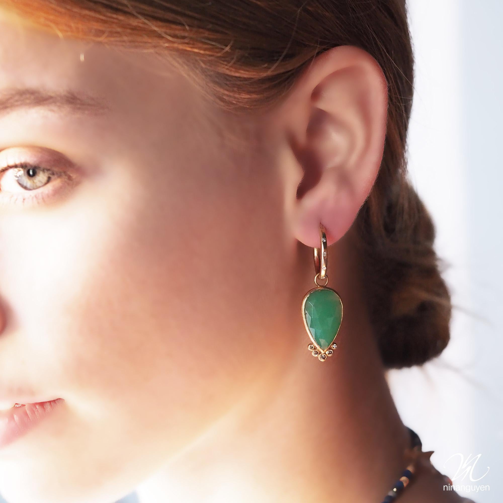 With vibrant chrysoprase in a petal-like pear shape, the diamond-accented Mia Medium Gold Charms bloom with any of our hoops and mix well with other styles.

Nina Nguyen Design's patent-pending earrings have an element on the back of the stud or