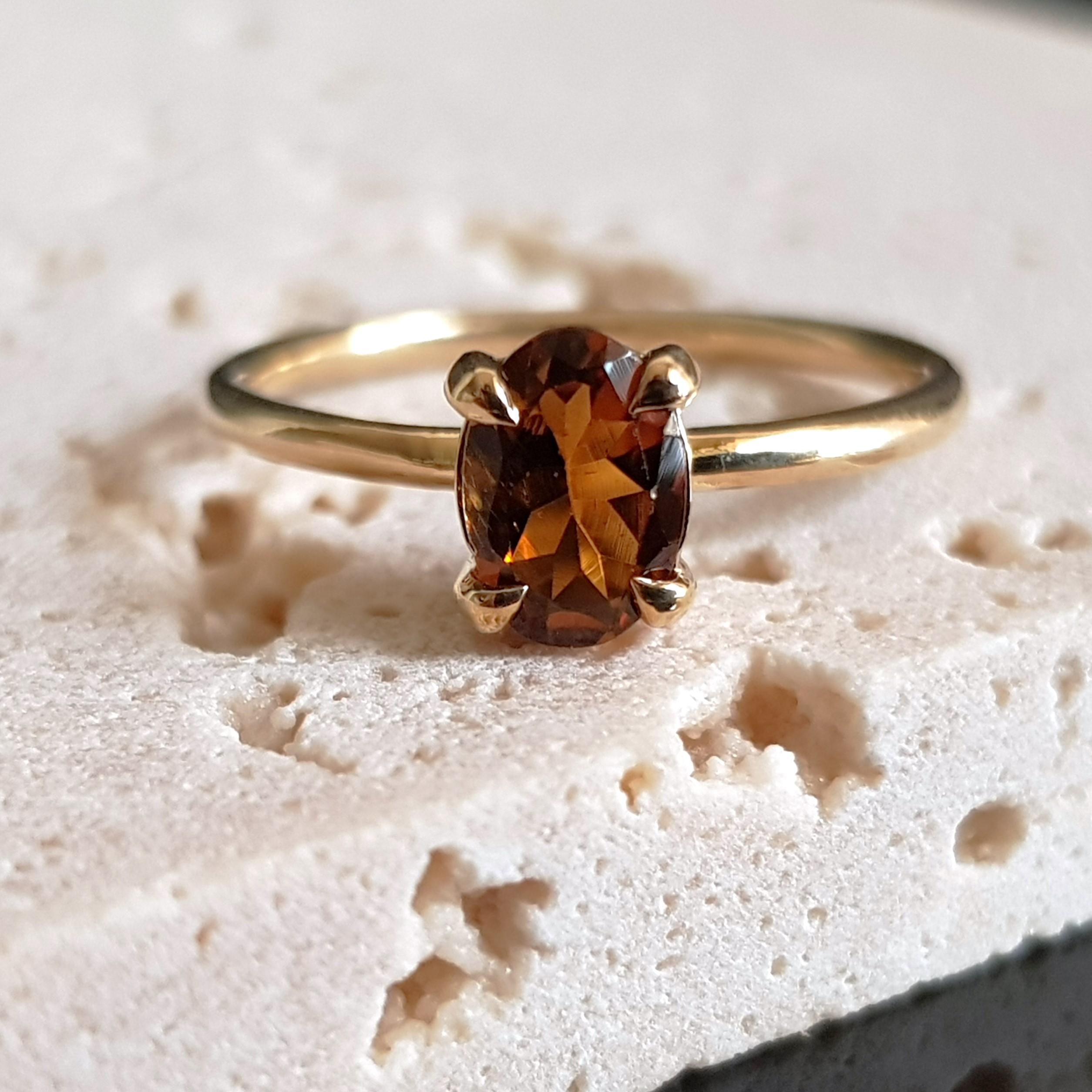 An embodiment of simply luxury, this stunning yellow gold ring features an oval cut yellow tourmaline gemstone. The precious gemstones are claw set, allowing the maximum amount of light to travel through the stones and accentuating the captivating