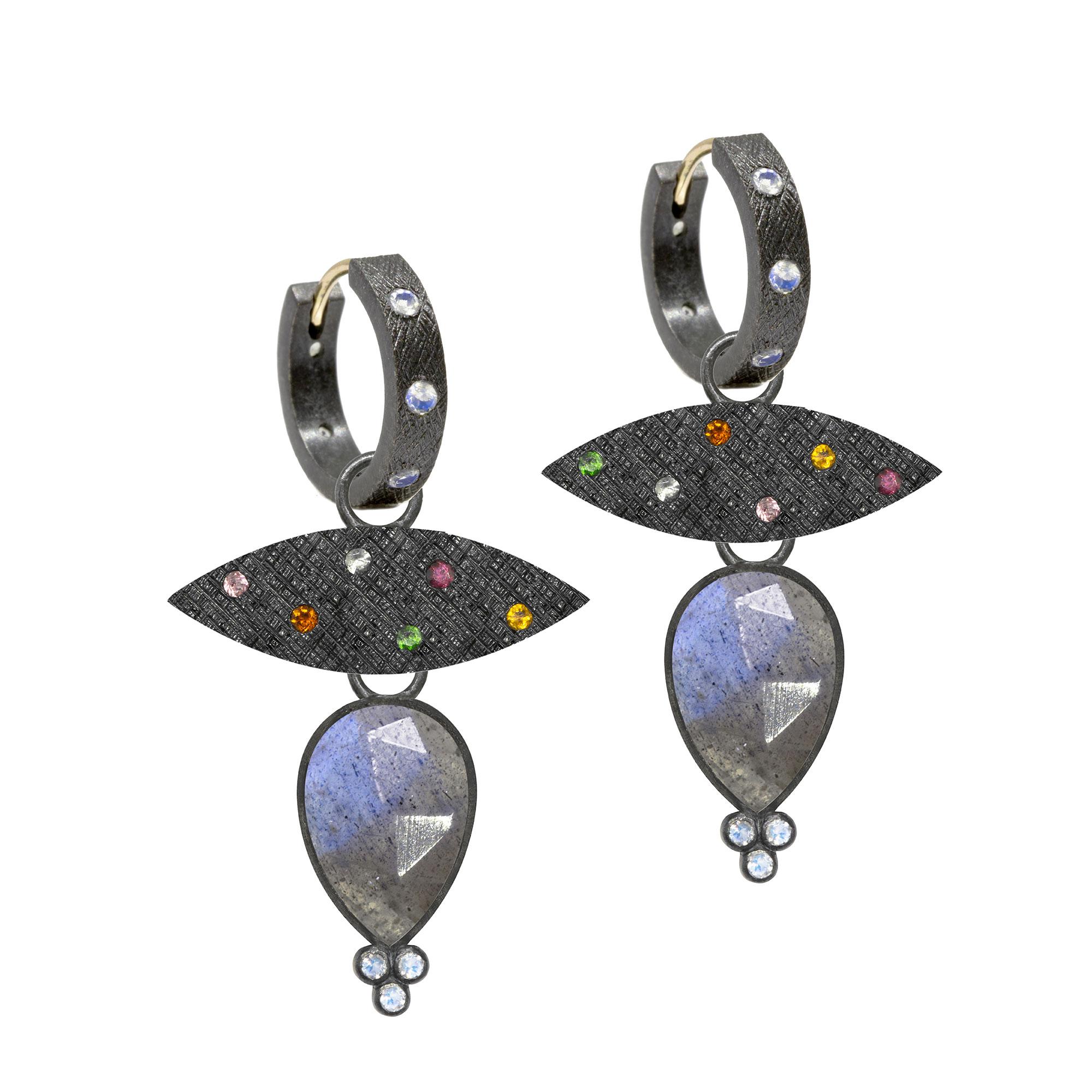 Nina Nguyen Design's patent-pending earrings have an element on the back of the stud or charm to allow these pieces to transformed into multi-use, stackable and convertible styling. It can be turned into a pendant and worn on a necklace, or used as