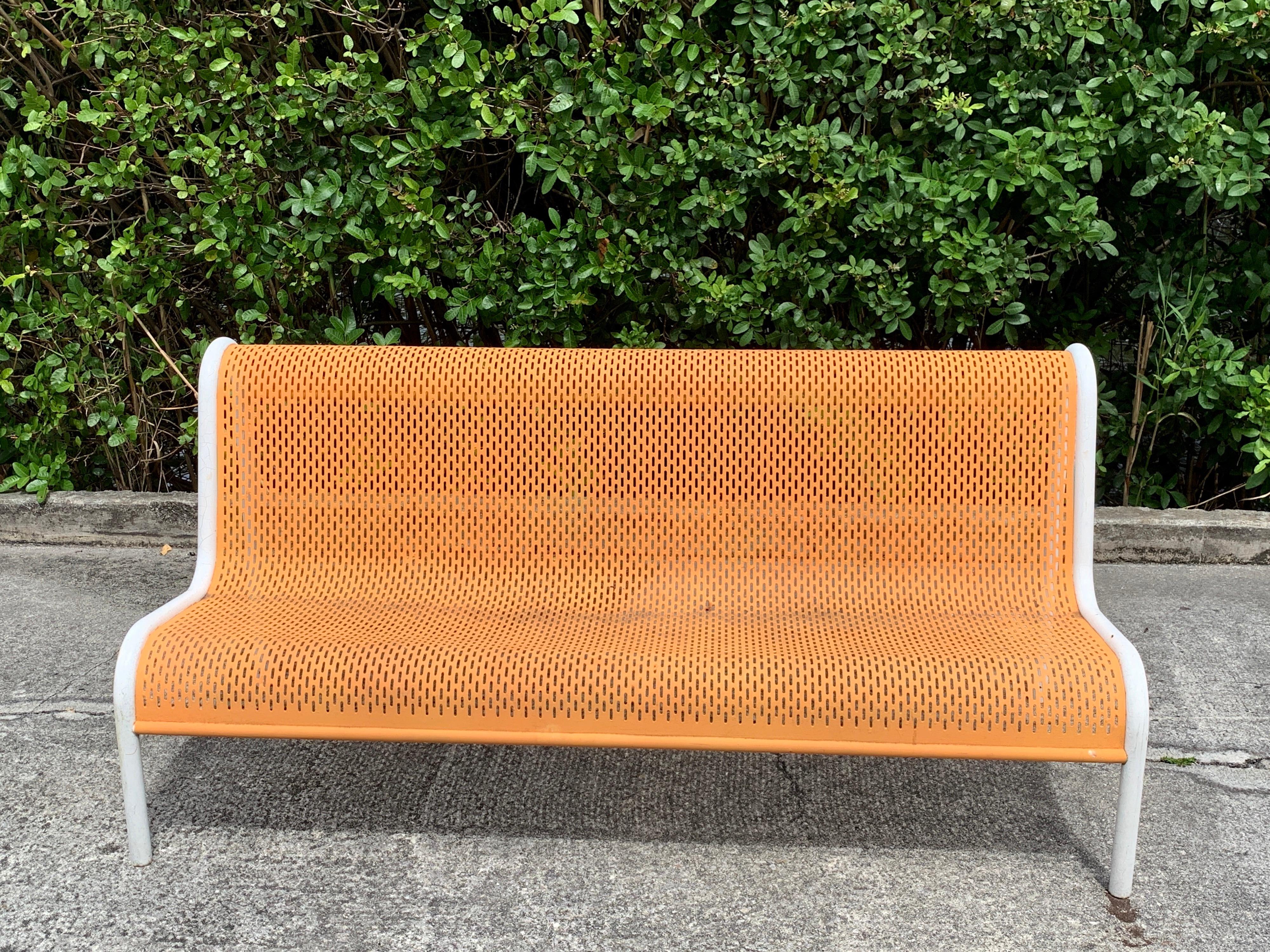 Miami modern wrought iron sculptural long bench, With flowing piereced back and seat rest, in vintage orange and white, ready for any color or powder coating of your choice.
