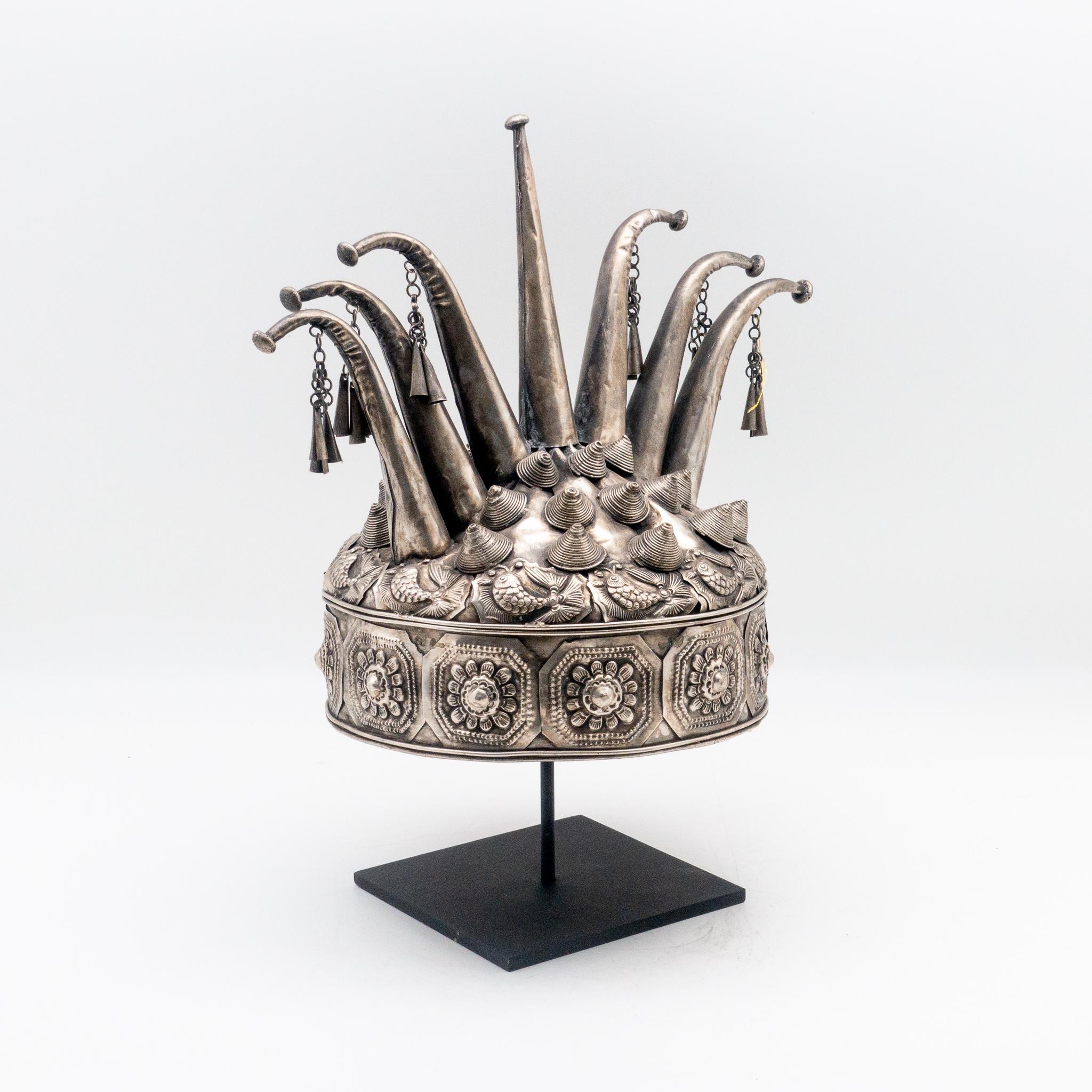 Metal Miao minority tribe headdress with intricate fish and flower motifs, from the early 20th century on a custom black painted metal mount.
 