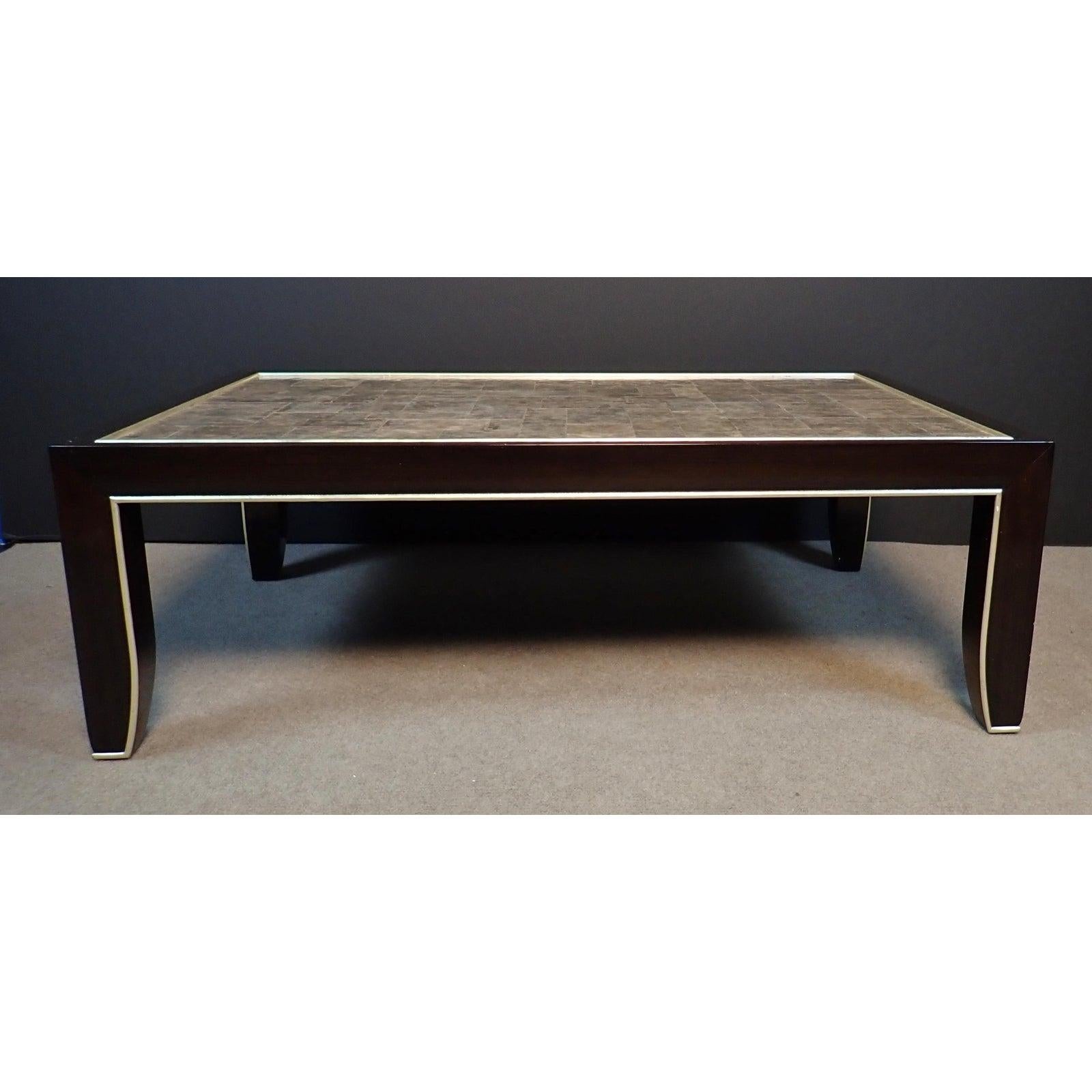  Mica and lacquered Art Deco inspired wood coffee table. Beautiful Mica top modern cocktail table with clean lines. Brown-black painted finish with silver leaf trim.