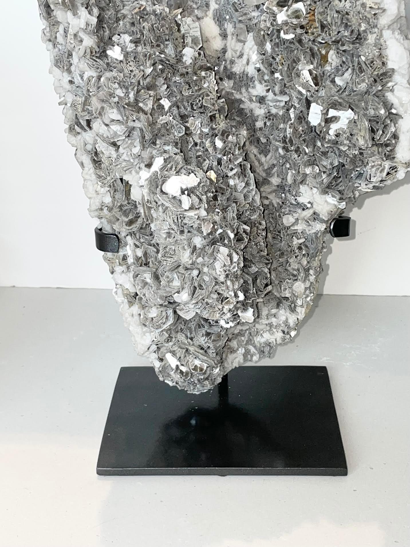 Brazilian large piece of mica mounted on a custom steel stand.
Mica is a shiny silicate mineral with a layered structure, found as minute scales
 in granite and other rocks, or as crystals.
Measures: Stand 6.5