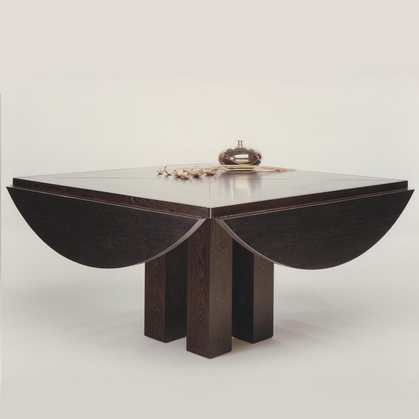 This elegant squared table is extendible and can be made in Italian walnut wood, American dark walnut, maple wood, cherry wood, durmast oak wood, or durmast oak with a wenge color. The solid wood adds elegance and warmth to this piece whose top