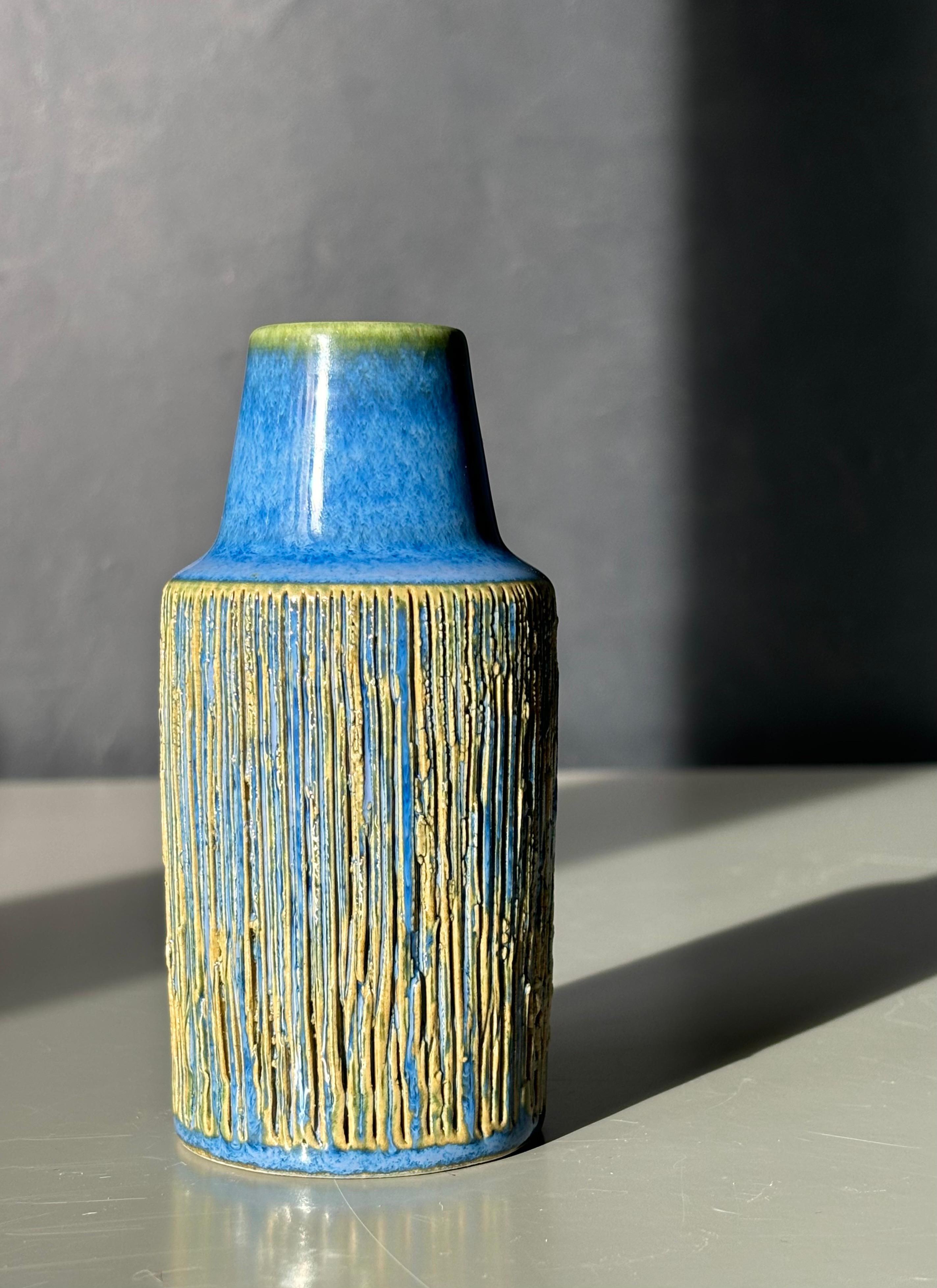 Handmade Danish midcentury modern vase made by Michael Andersen & Son on the island of Bornholm in the 1960s. Shiny deep blue glaze with hand-carved incised vertical lines along the body. Signed and numbered under base. Beautiful vintage condition.