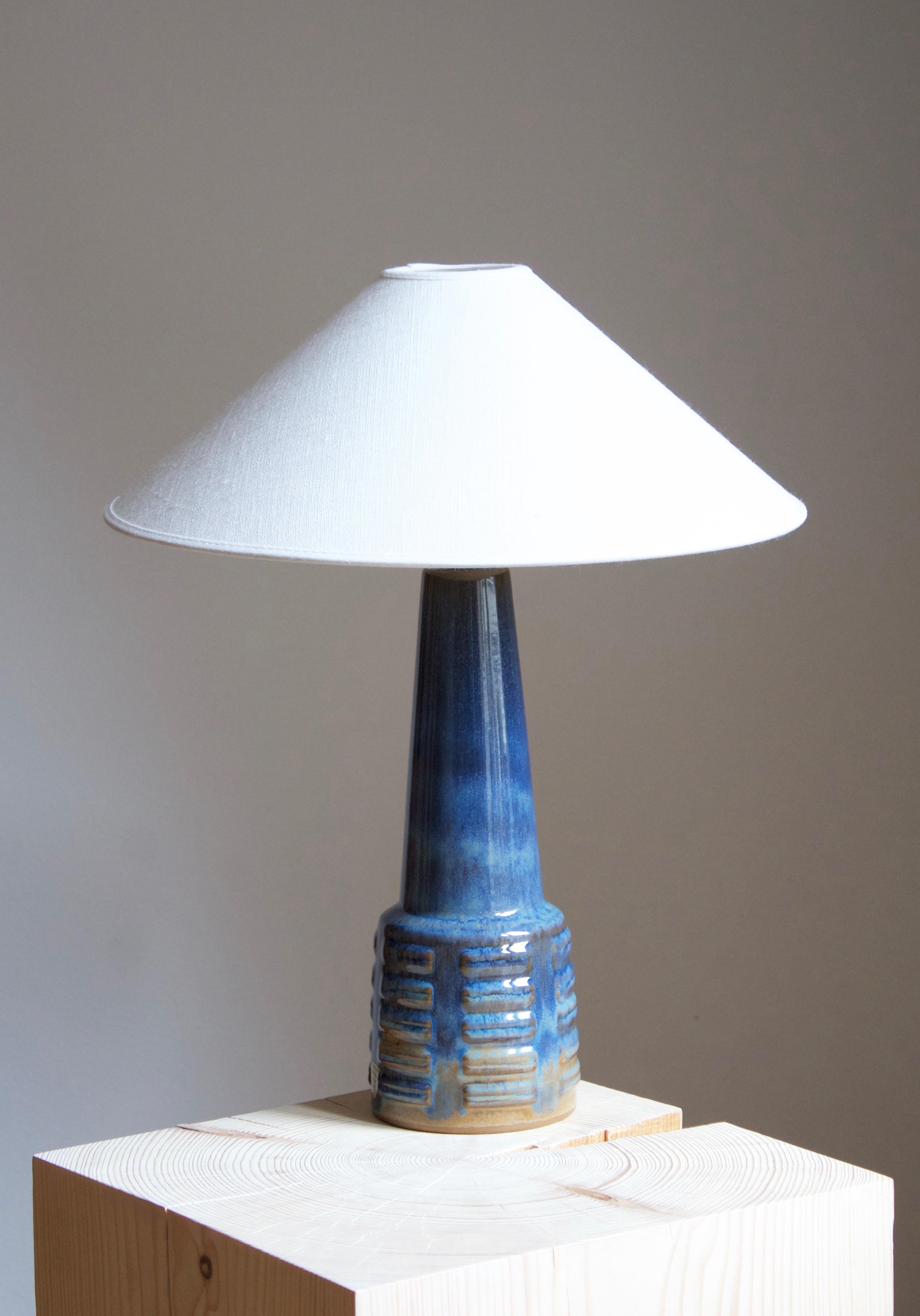 A table lamp produced by Michael Andersen Keramik. In stoneware. Marked. With production label

Stated dimensions exclude lampshade. Height includes socket. Sold without lampshade.

Other ceramicists of the period include Axel Salto, Arne Bang,