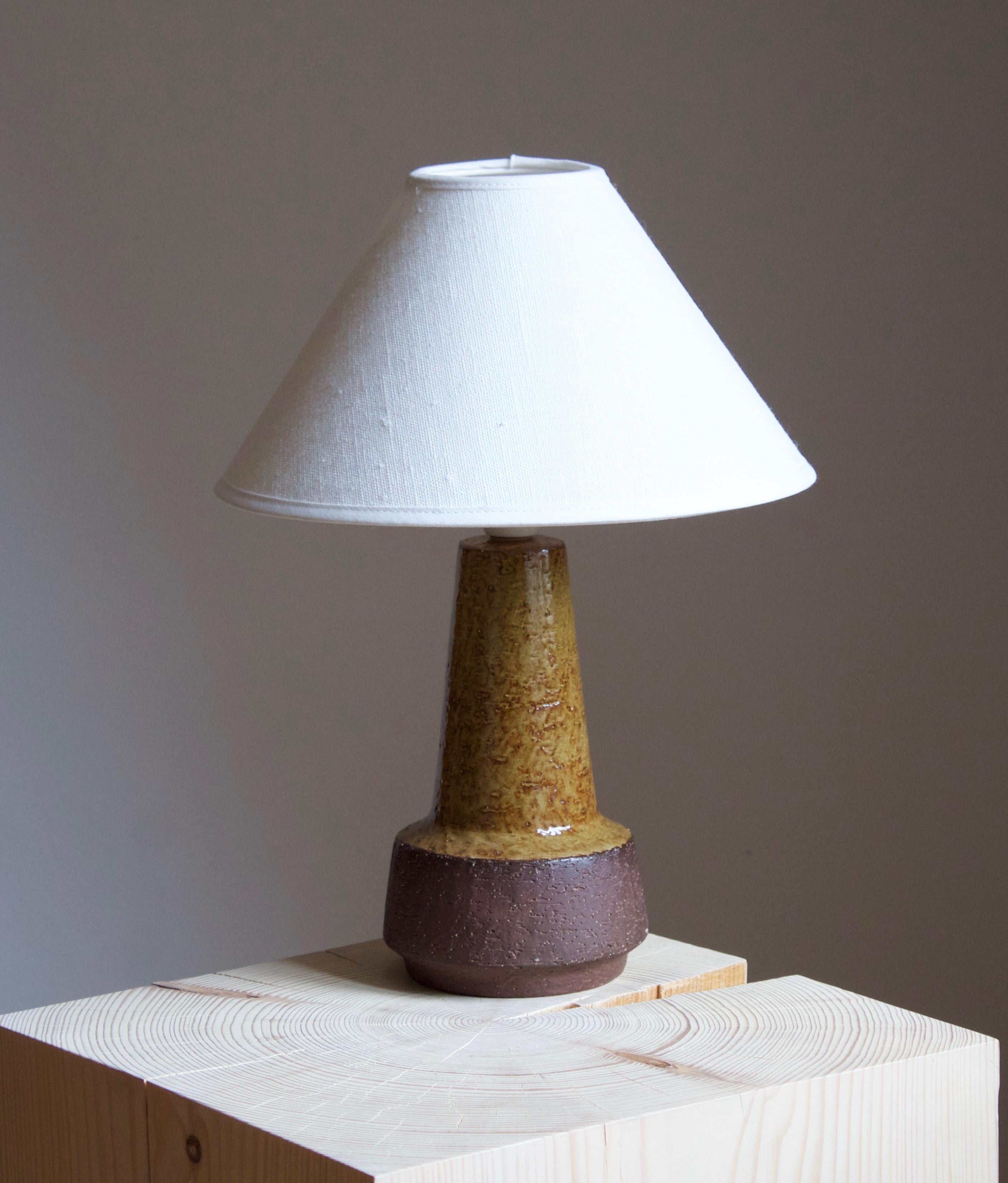 A table lamp produced by Michael Andersen Keramik. In stoneware. Marked.

Stated dimensions exclude lampshade. Height includes socket. Sold without lampshade.

Glaze features a brown colors.

Other ceramicists of the period include Axel Salto, Arne
