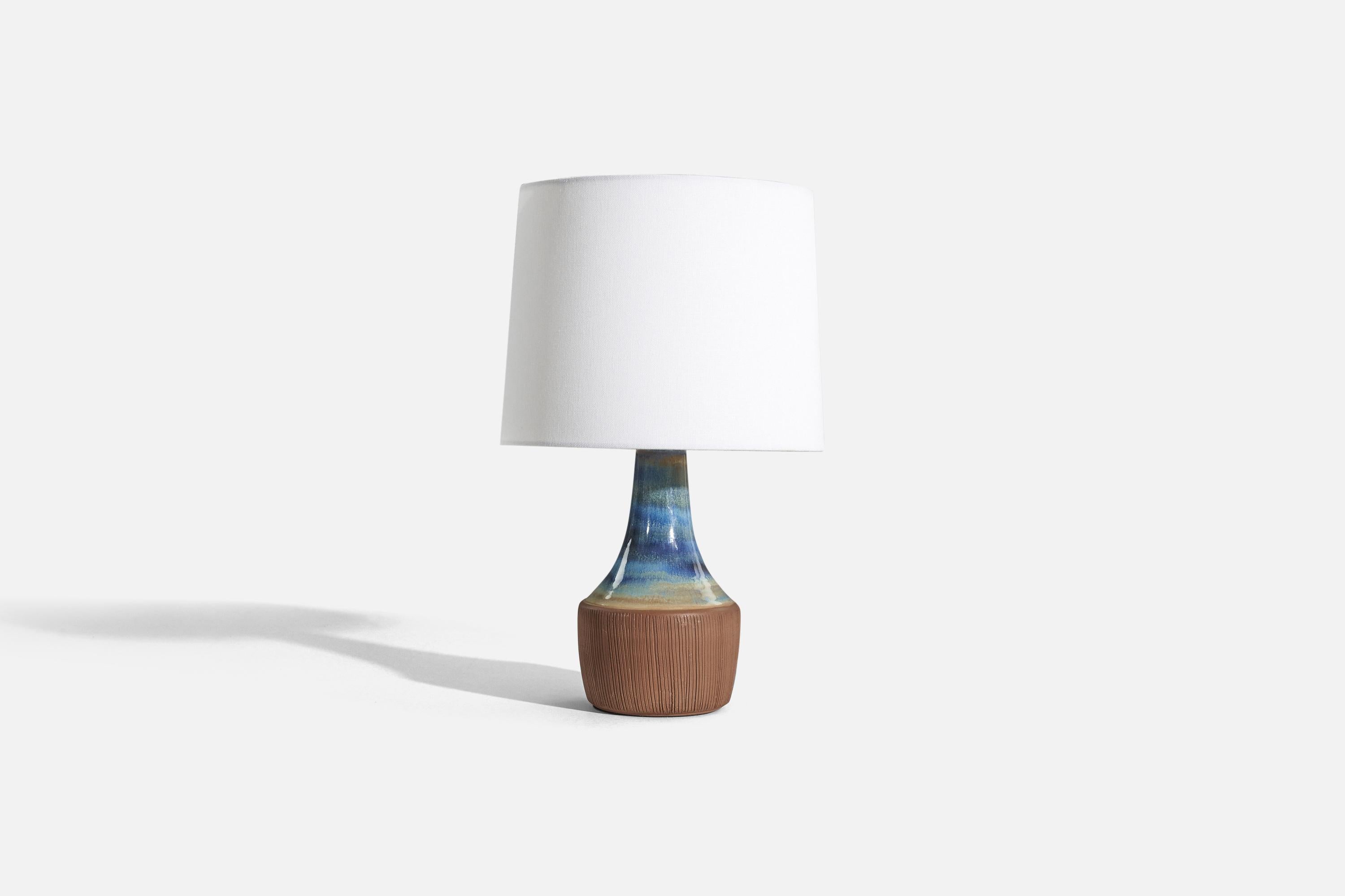 A blue and brown, glazed stoneware table lamp designed and produced by Michael Andersen Keramik, Bornholm, Denmark, 1960s. 

Sold without lampshade. 
Dimensions of Lamp (inches) : 12.625 x 5.125 x 5.125 (H x W x D)
Dimensions of Shade (inches) : 9 x