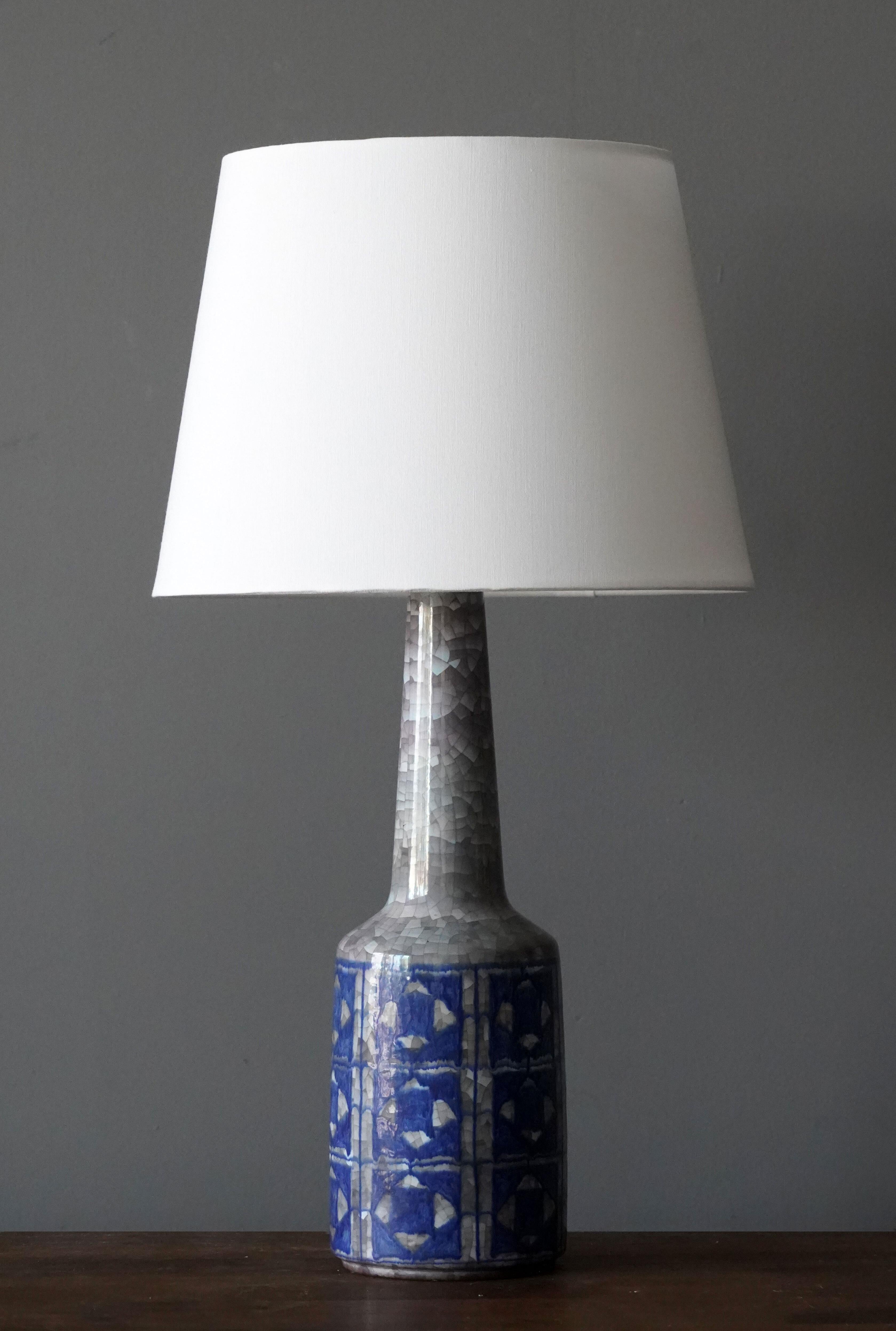 A table lamp produced by Michael Andersen Keramik. In hand painted stoneware 

Purchase excludes lampshade. Stated measurements excluding lampshade.

Glaze features blue-grey colors.

Other ceramicists of the period include Axel Salto, Arne Bang,