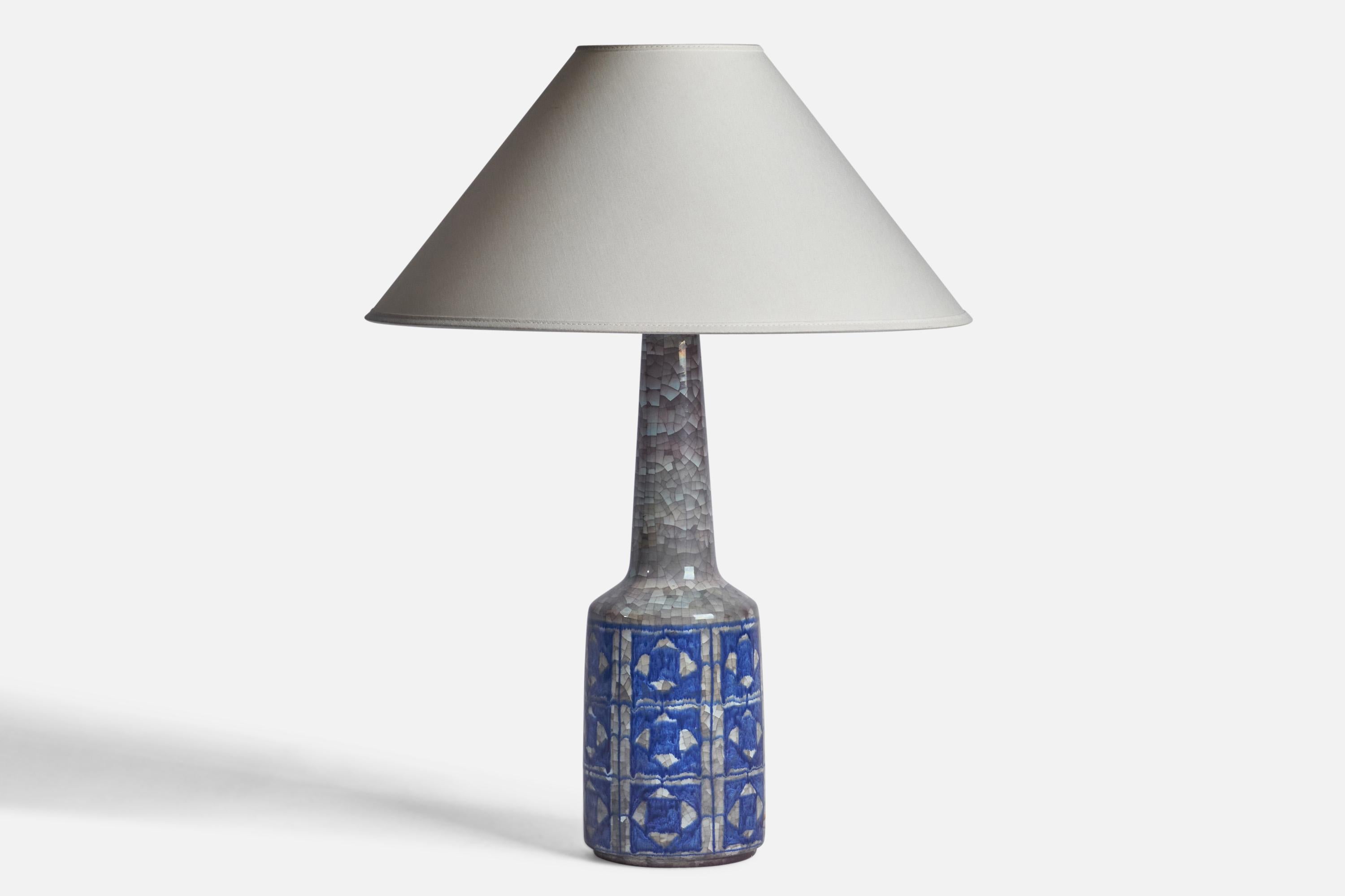 A blue and grey-glazed table lamp designed and produced by Michael Andersen, Denmark, c. 1950s.

Dimensions of Lamp (inches): 16.75” x 5” Diameter
Dimensions of Shade (inches): 4.5” Top Diameter x 16” Bottom Diameter x 7.25” H
Dimensions of Lamp