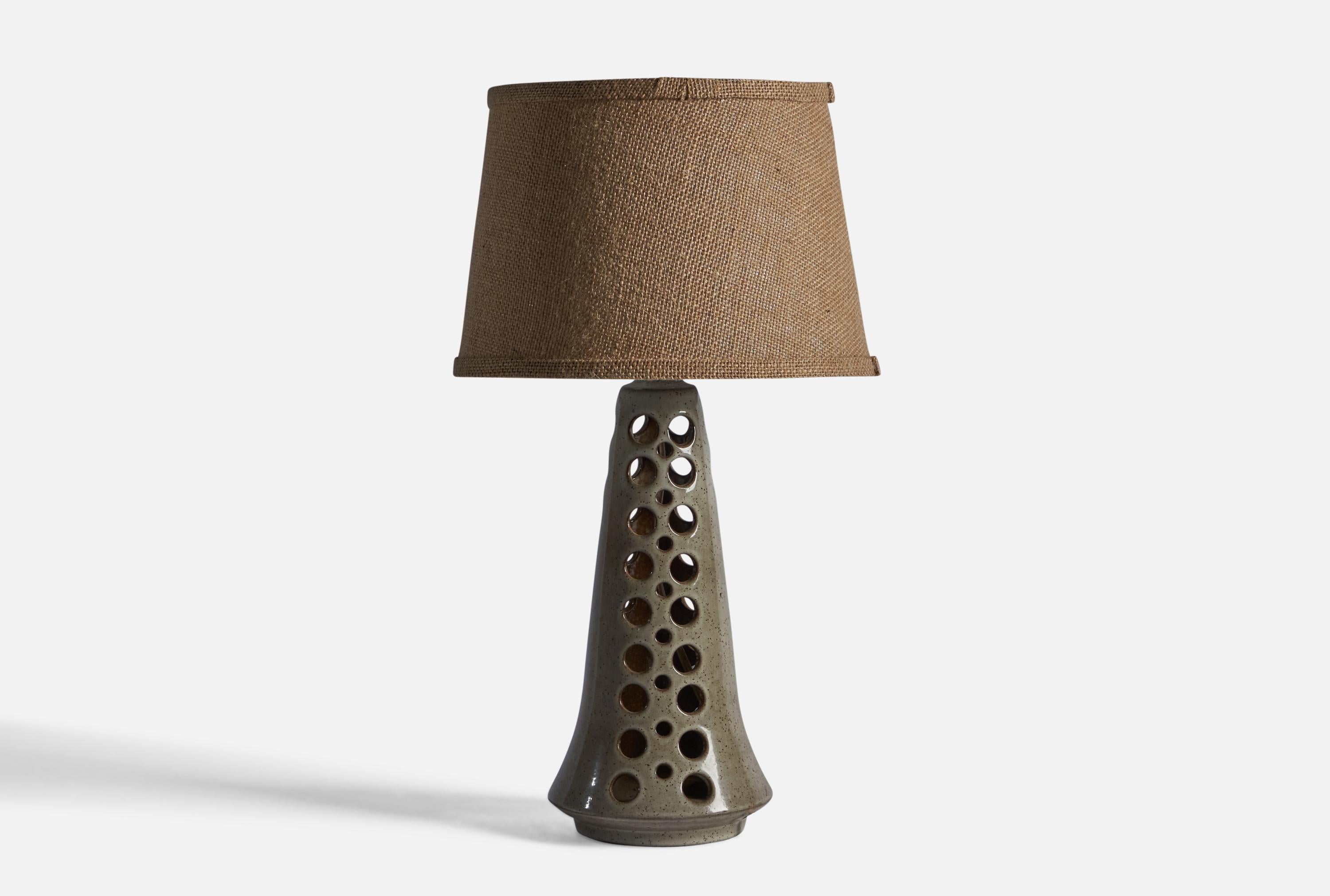A grey-glazed perforated stoneware table lamp, designed and produced by Michael Andersen, Bornholm, Denmark, c. 1960s.

Dimensions of Lamp (inches): 14.75