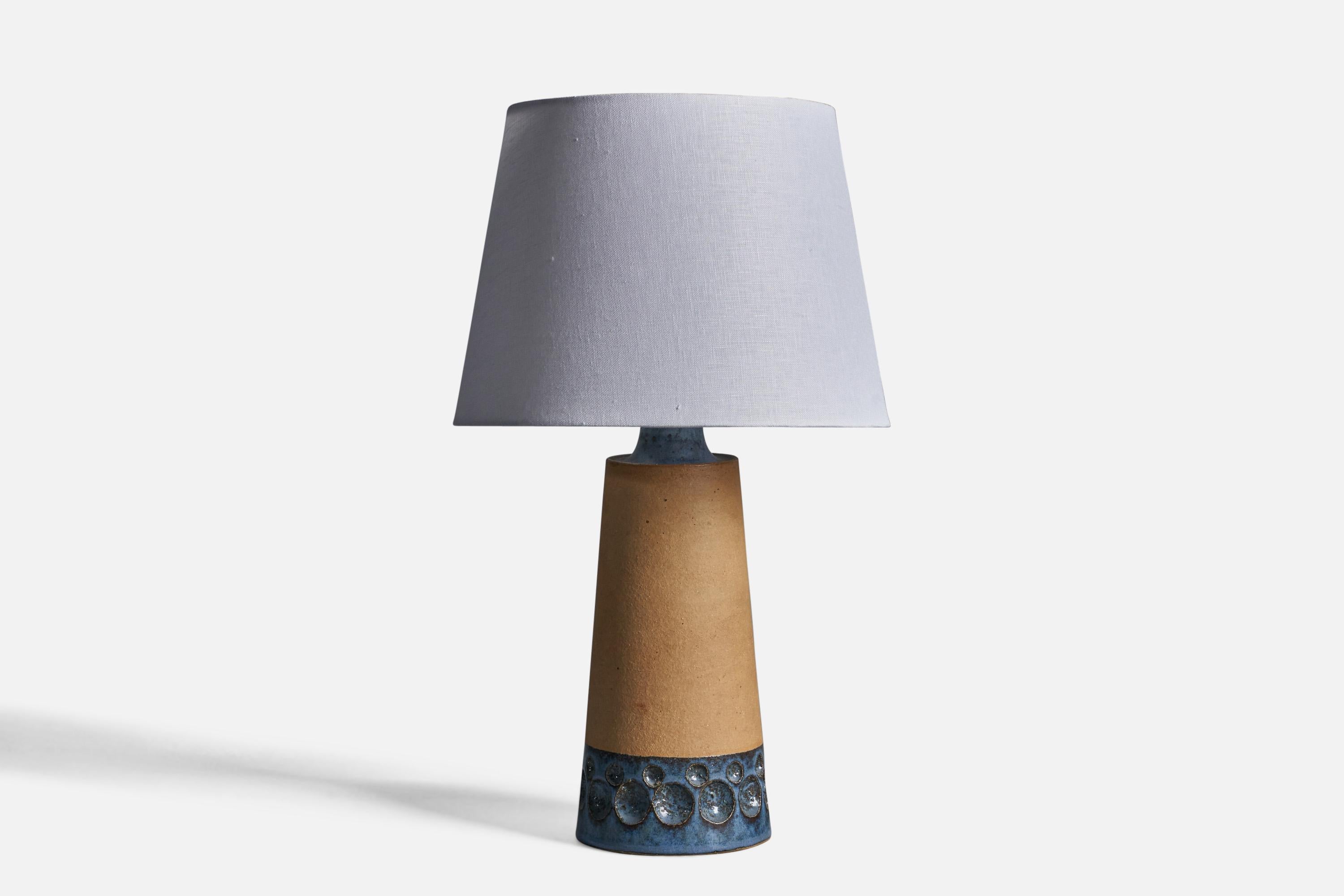 A semi-glazed blue and beige stoneware table lamp, designed and produced by Michael Andersen, Bornholm, Denmark, 1960s.

Dimensions of Lamp (inches): 15.5