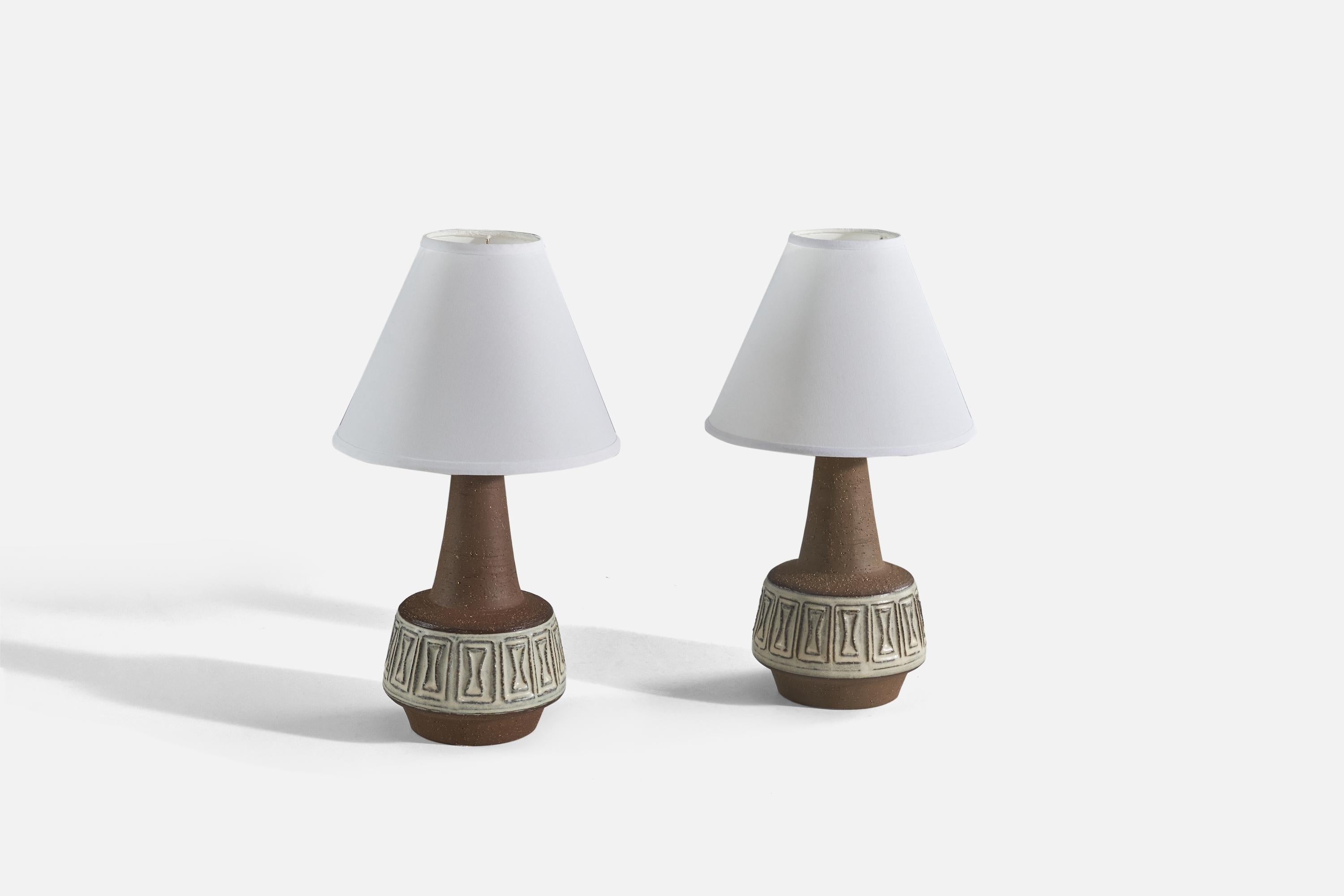A pair of brown, glazed stoneware table lamps designed and produced by Michael Andersen Keramik, Denmark, 1960s. 

Sold without lampshade. 
Dimensions of Lamp (inches) : 13.31 x 6.75 x 6.75 (Height x Width x Depth)
Dimensions of Shade (inches) :