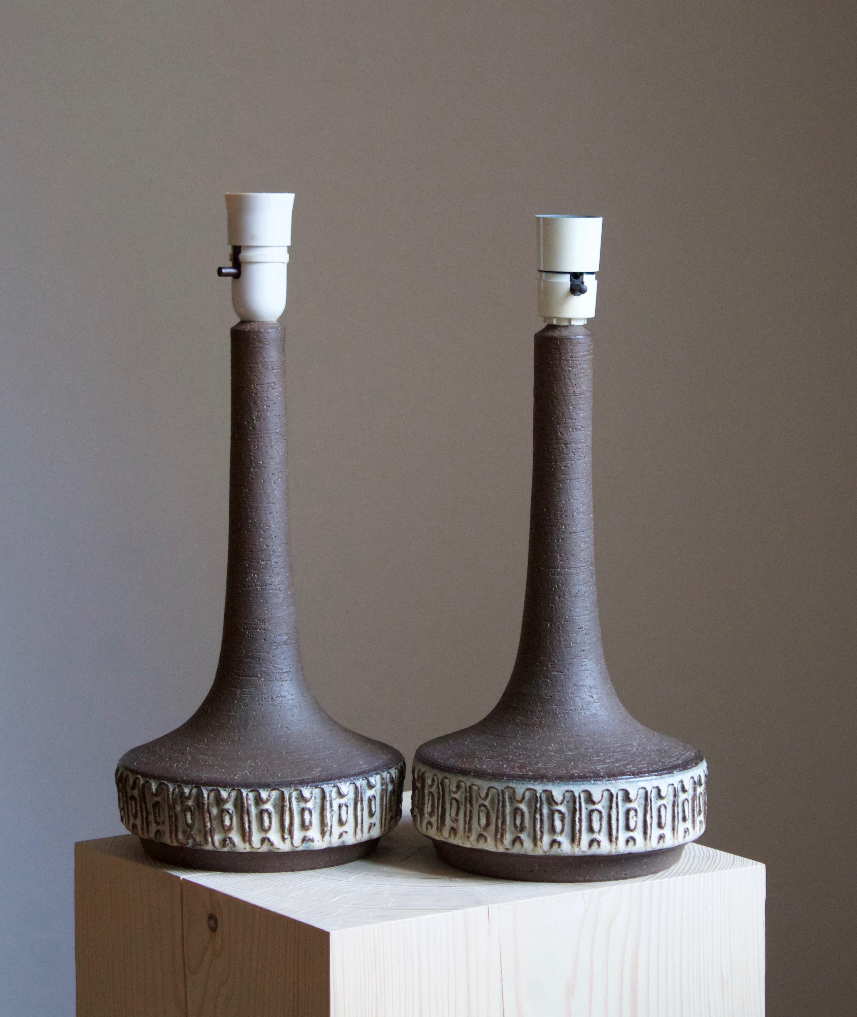 A pair of table lamps produced by Michael Andersen Keramik. In stoneware. Marked.

Stated dimensions exclude lampshade. Height includes socket. Sold without lampshade. Due to the hand-produced nature each lamp is of slightly varying size and shape,