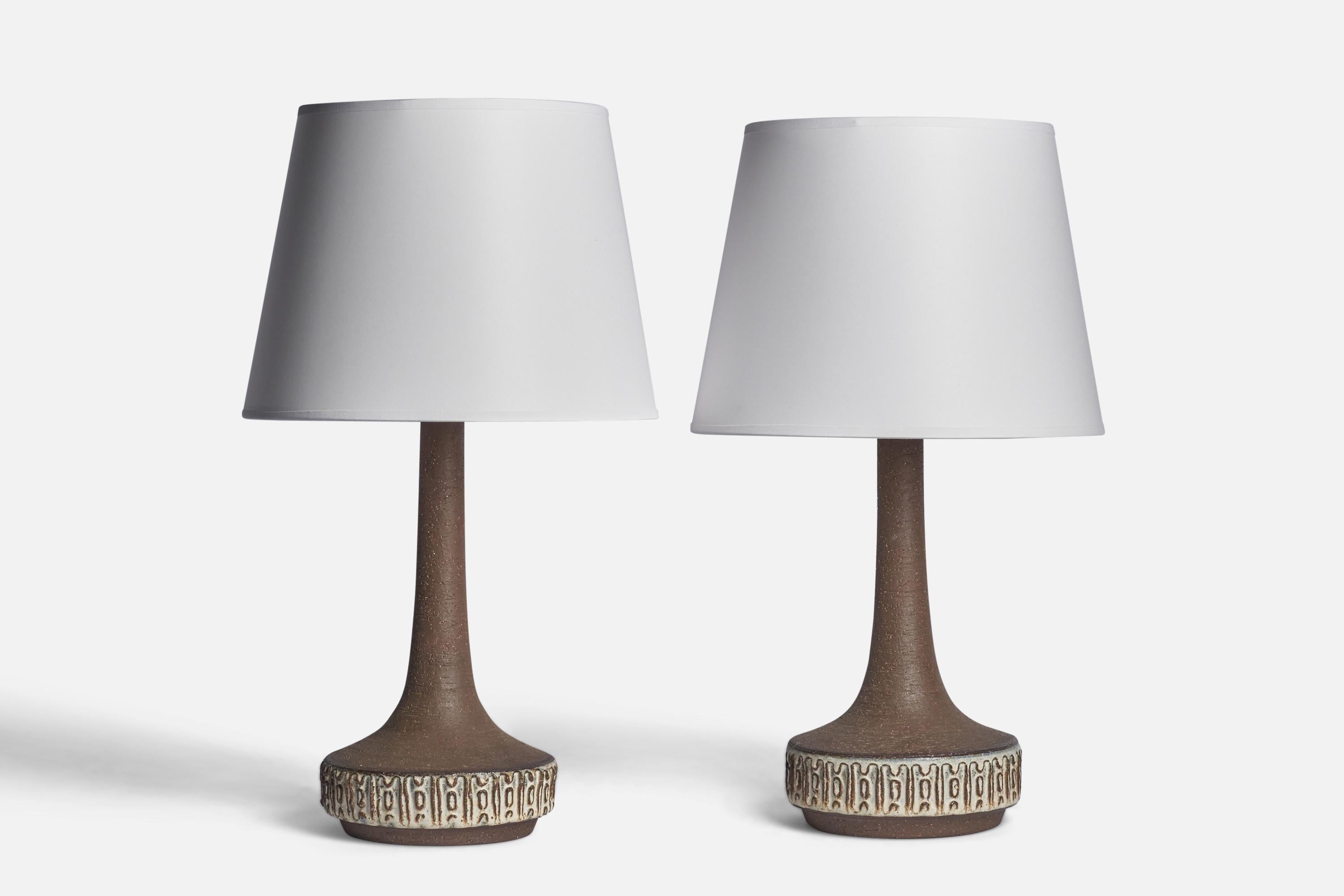 A pair of brown and light grey-glazed stoneware table lamps designed and produced by Michael Andersen, Bornholm, Denmark, 1960s.

Dimensions of Lamp (inches): 15.5” H x 7” Diameter
Dimensions of Shade (inches): 9” Top Diameter x 12” Bottom Diameter