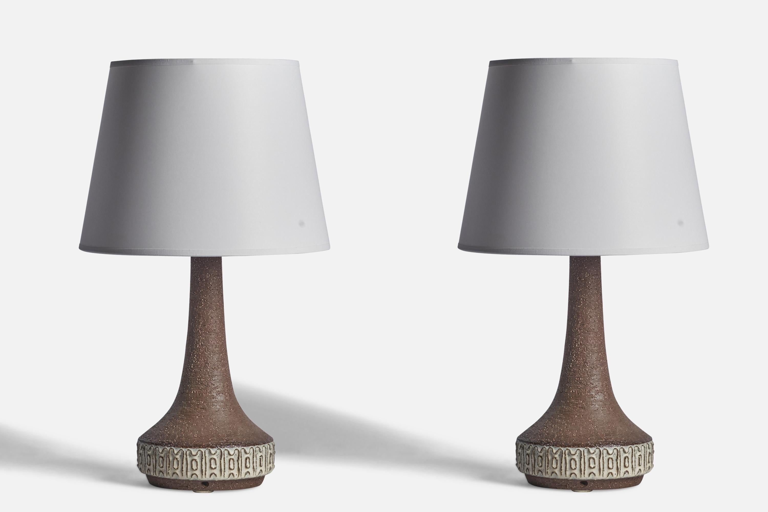 A pair of grey-glazed stoneware table lamps designed and produced by Michael Andersen, Bornholm, Denmark, 1960s.

Dimensions of Lamp (inches): 15.5” H x 6.5” Diameter
Dimensions of Shade (inches): 8.75” Top Diameter x 12” Bottom Diameter x 9” H